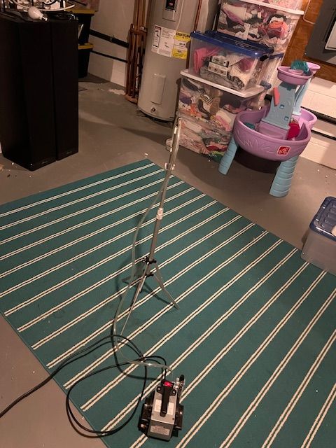 A woman wearing a black face mask is stretching her arms.