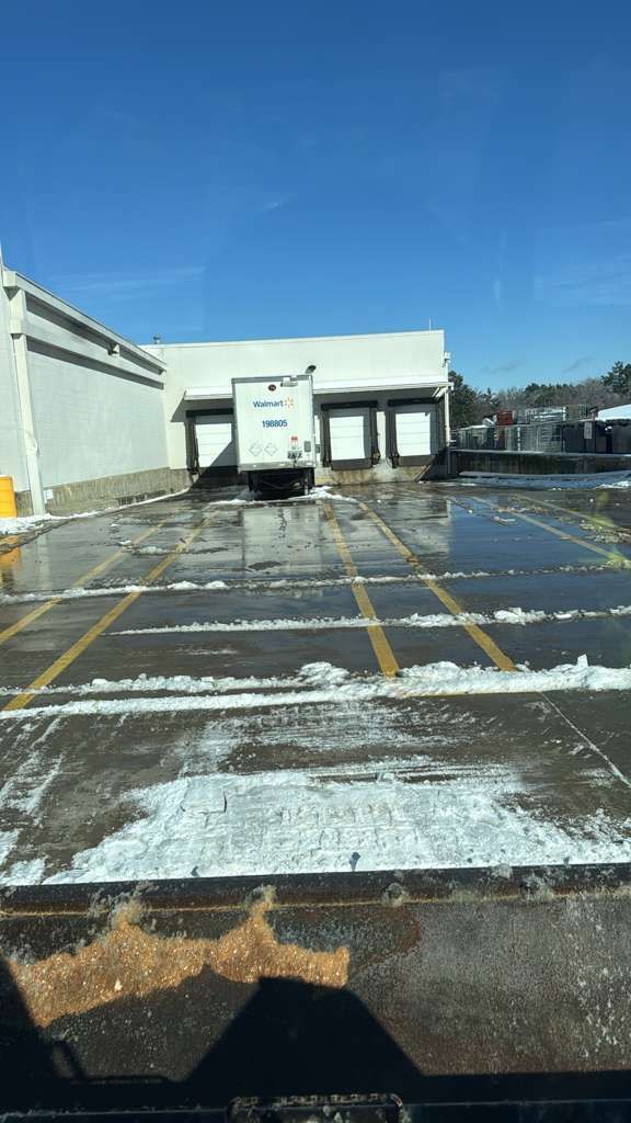 A Walmart trailer loading dock post snow removal and salting services.