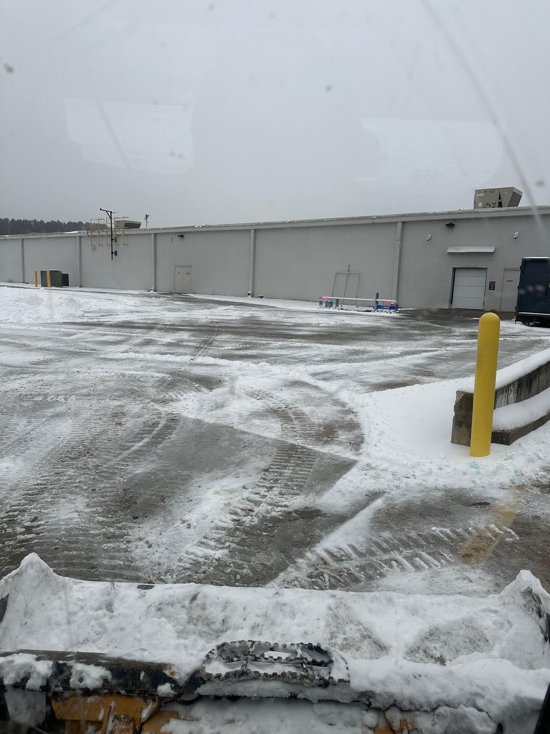 A parking lot post snow removal and salting services.