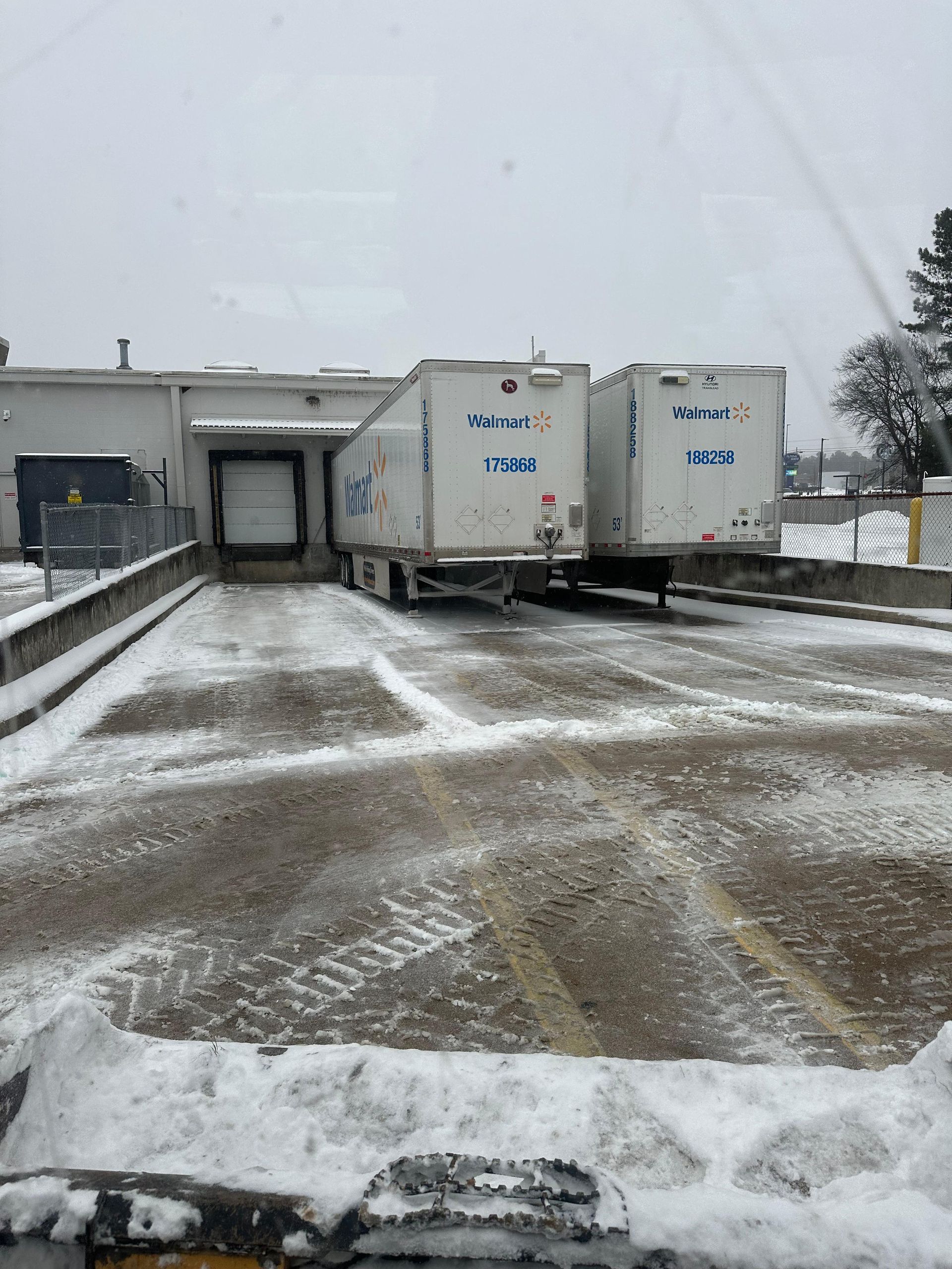 A Walmart semi docking station cleared of snow.