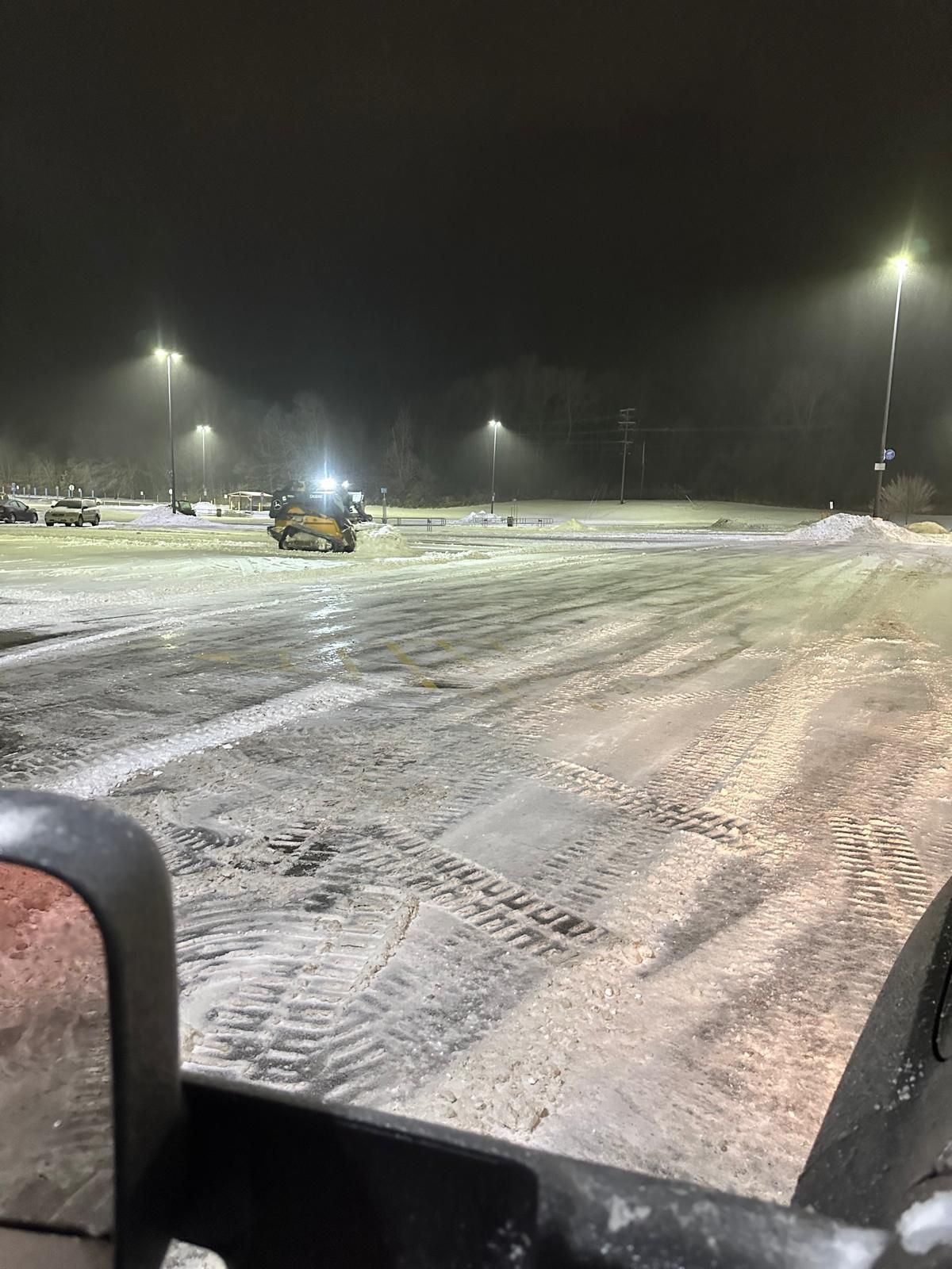 A Walmart parking lot being cleared of snow.
