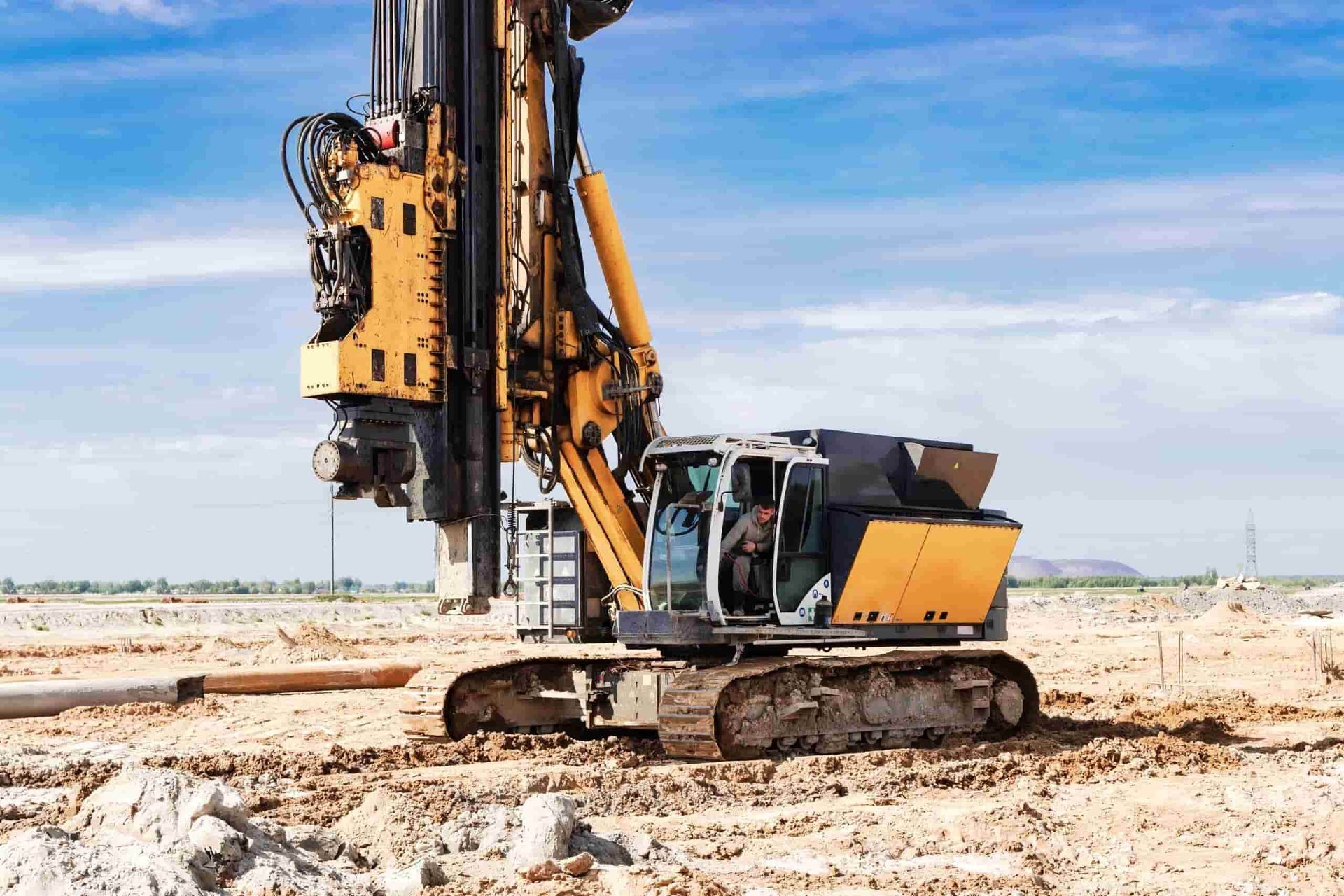 A Large Yellow And White Drill Is Sitting On Top Of A Dirt Field — Windscreen Ambulance In Kawana, QLD