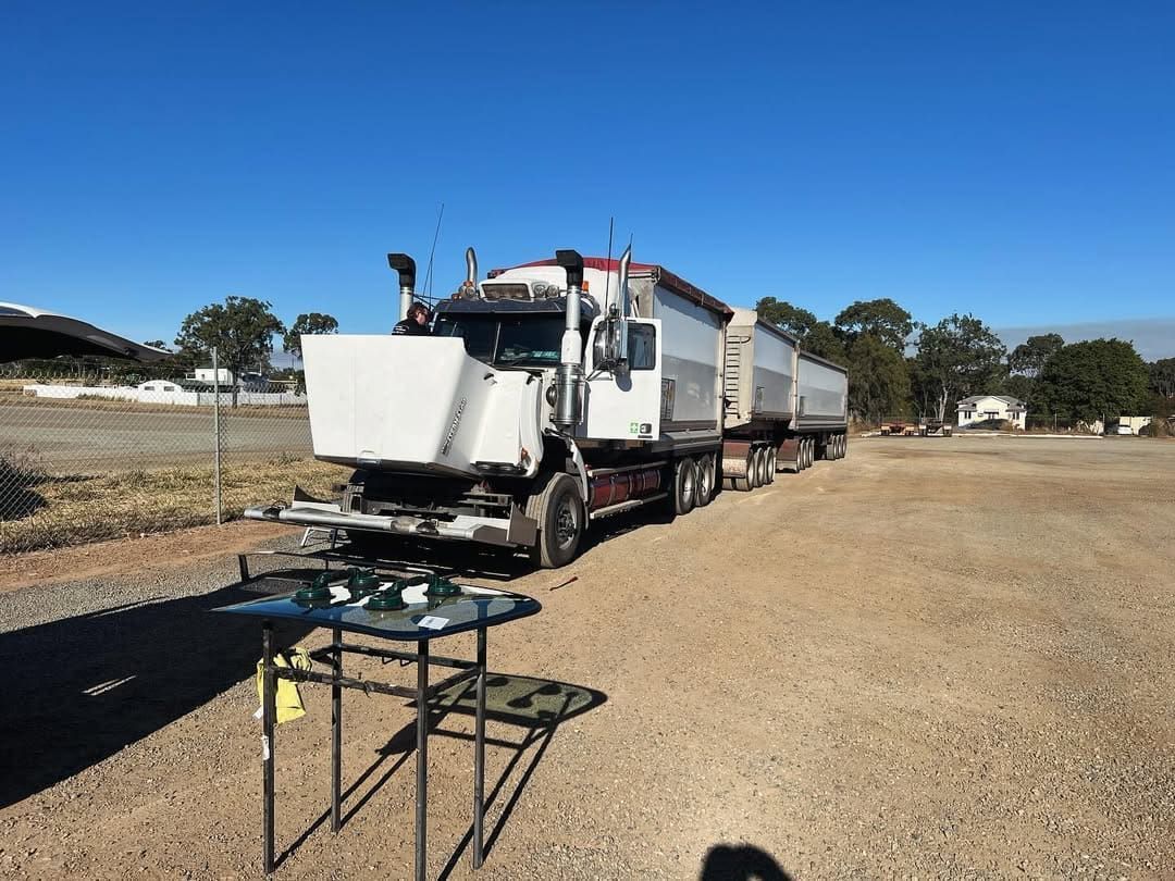 A Truck Is Parked In A Gravel Lot Next To A Table — Windscreen Ambulance In Kawana, QLD
