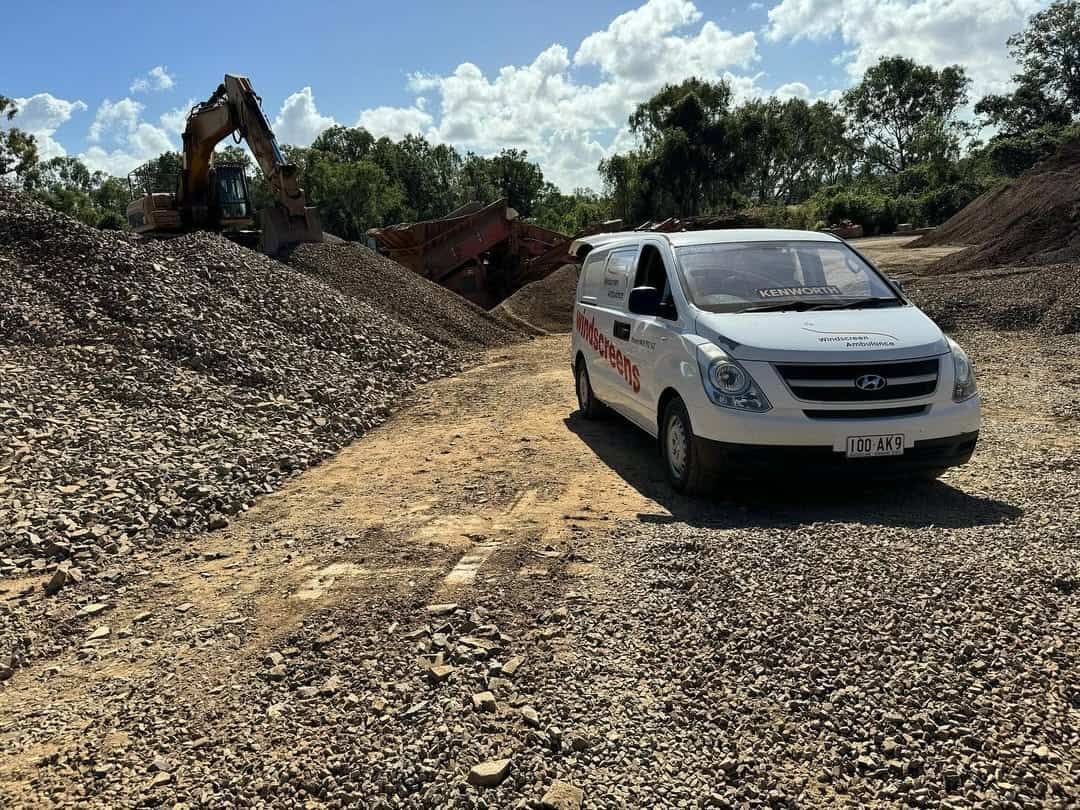 A White Van Is Parked On A Dirt Road In Front Of A Pile Of Gravel — Windscreen Ambulance In Kawana, QLD