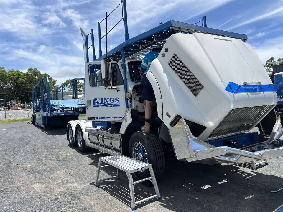 A Man Is Working On The Hood Of A Semi Truck — Windscreen Ambulance In Kawana, QLD