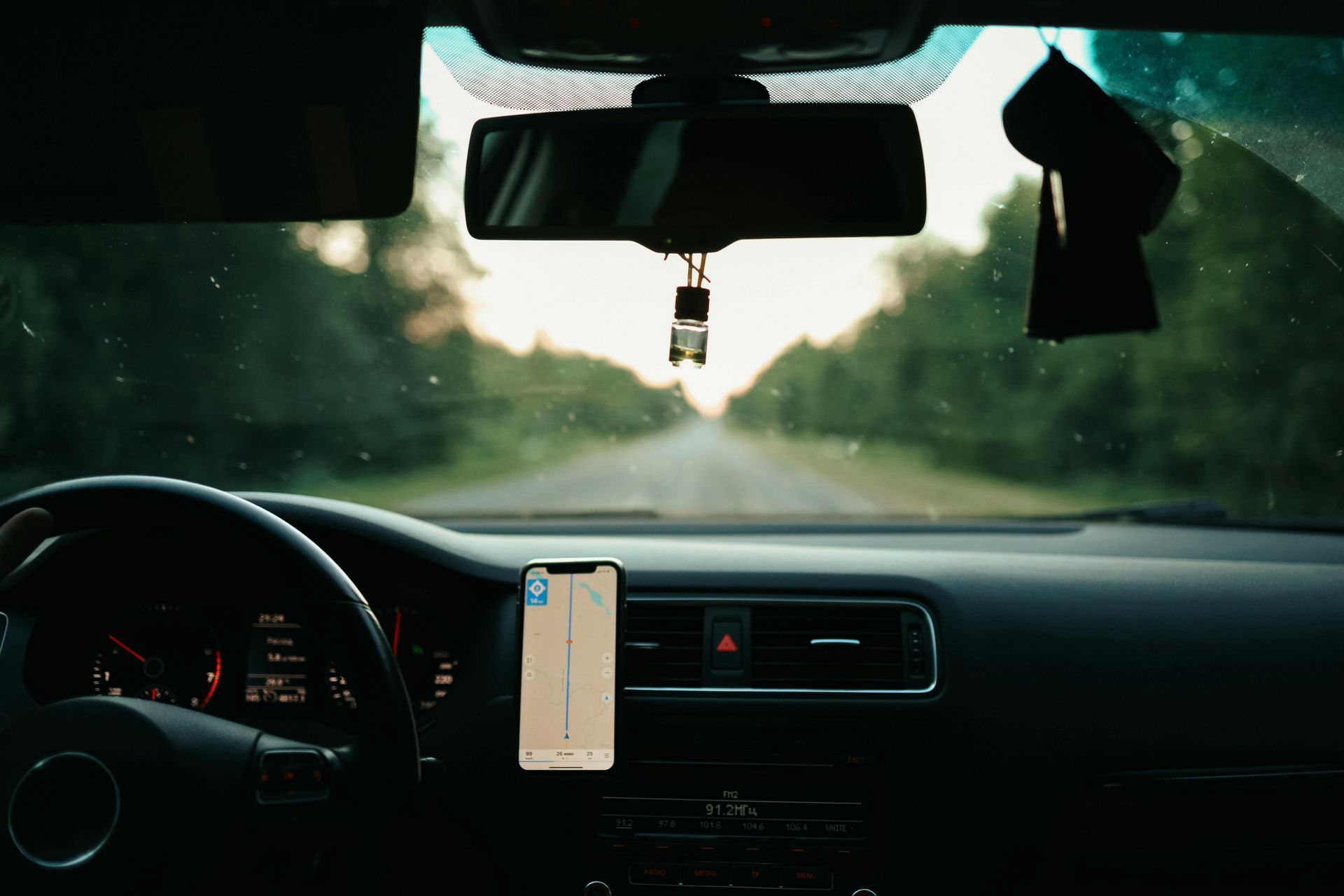 The Inside Of A Car With A Phone Hanging From The Rear View Mirror — Windscreen Ambulance In Kawana, QLD