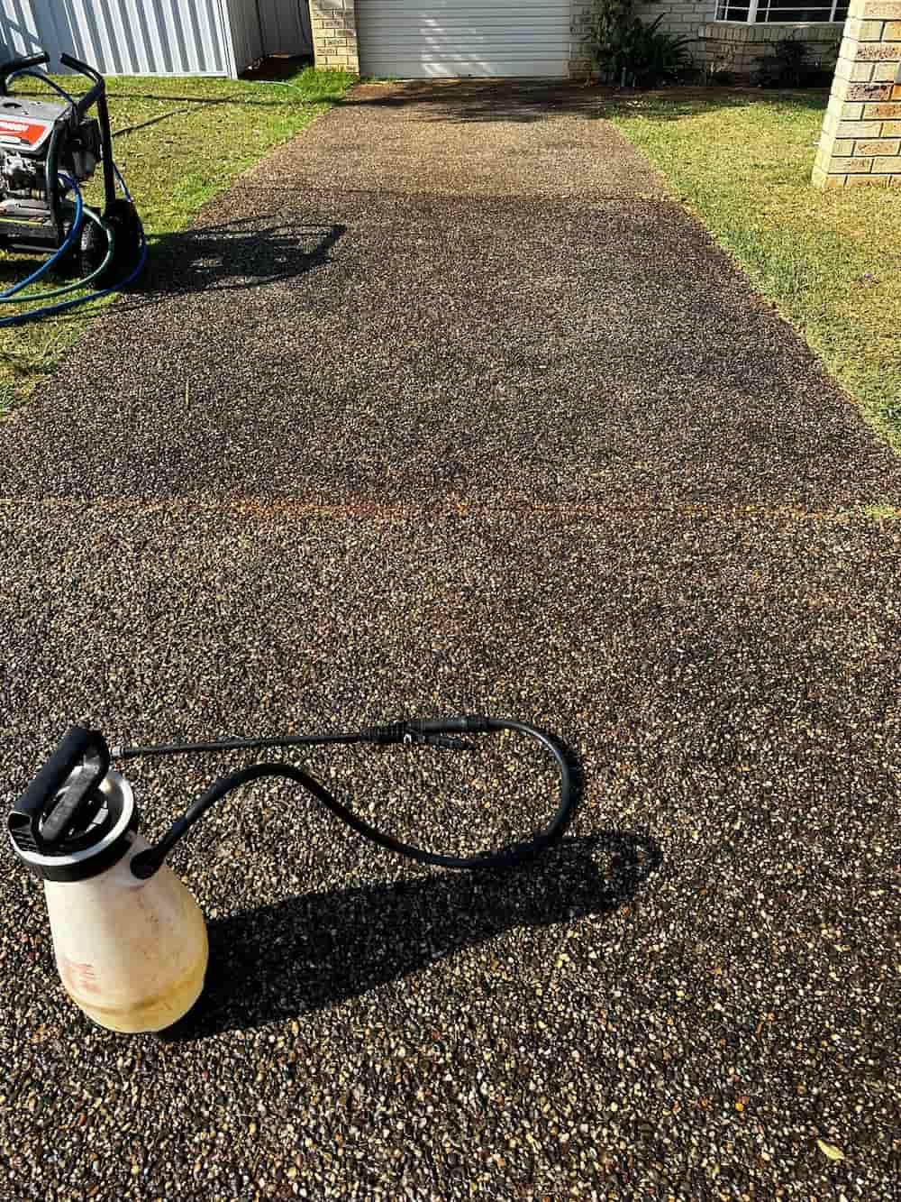 A Pressure Washer is Sitting on Top of a Concrete Driveway — Lighthouse pressure washing in Port Macquarie, NSW