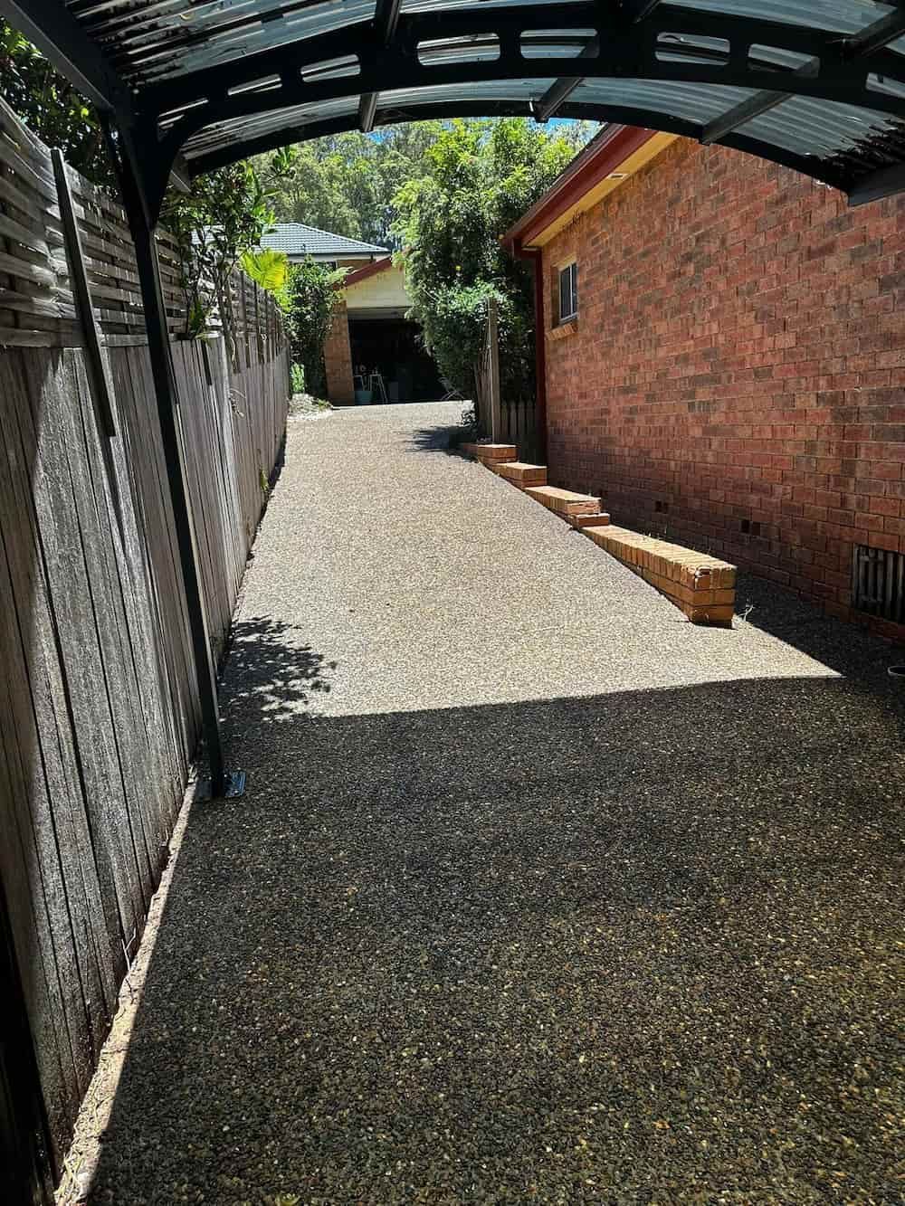 A Driveway Leading to a Brick House With a Carport — Lighthouse pressure washing in Wauchope, NSW