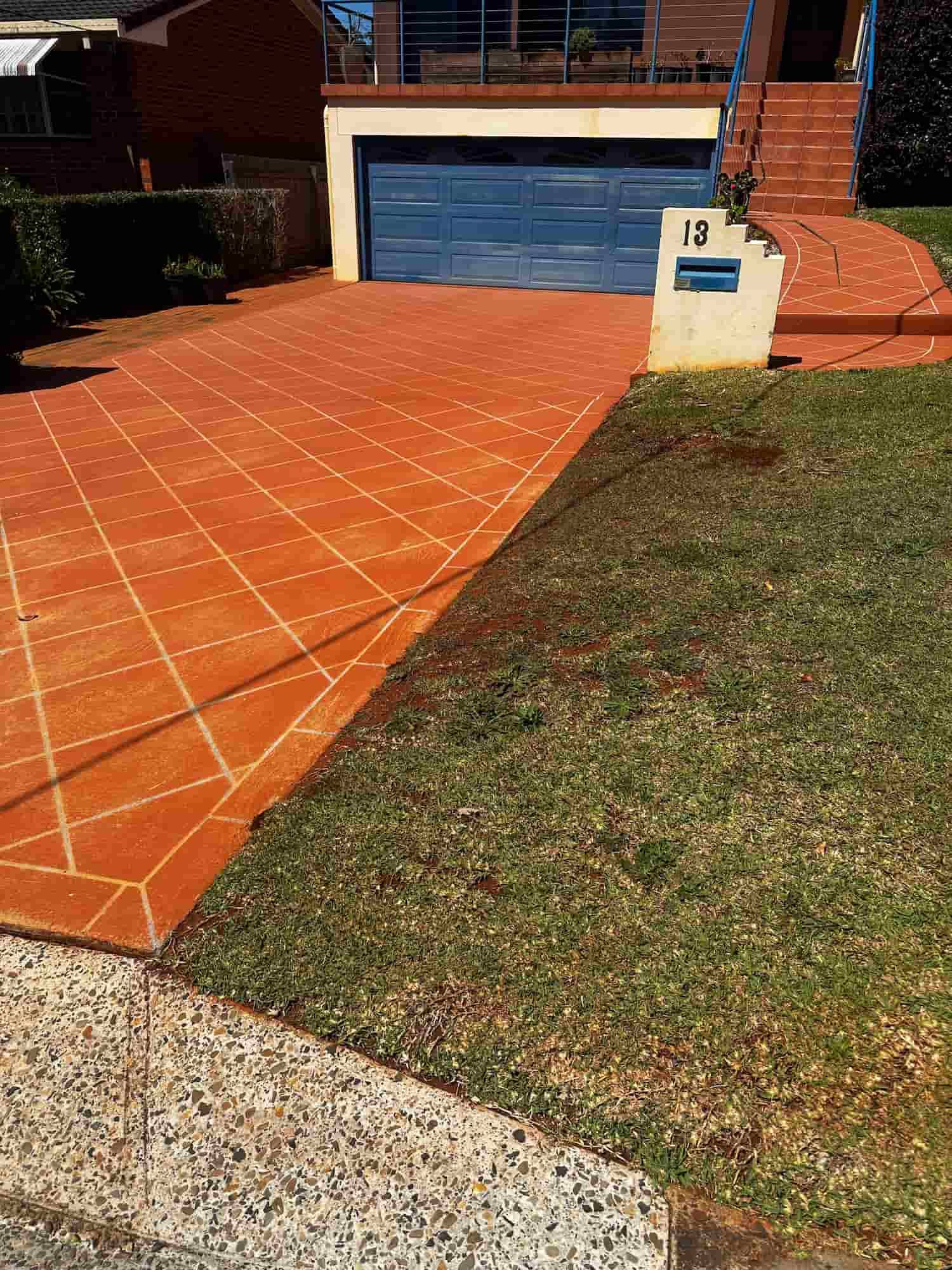 A Concrete Walkway in a Backyard With a Wooden Fence in the Background — Lighthouse pressure washing in Port Macquarie, NSW