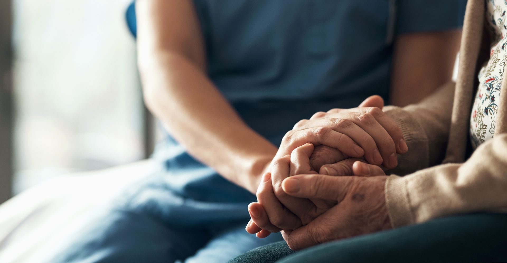 Closeup of nurse holding patient's hands, showing empathy, compassion, and support | Fort Worth, TX