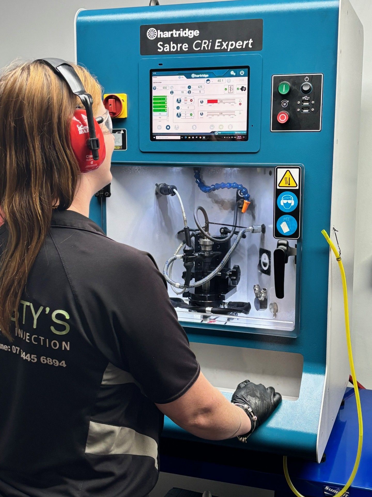 A Person Working On A Machine — Rusty's Diesel Injection in Browns Plains, QLD