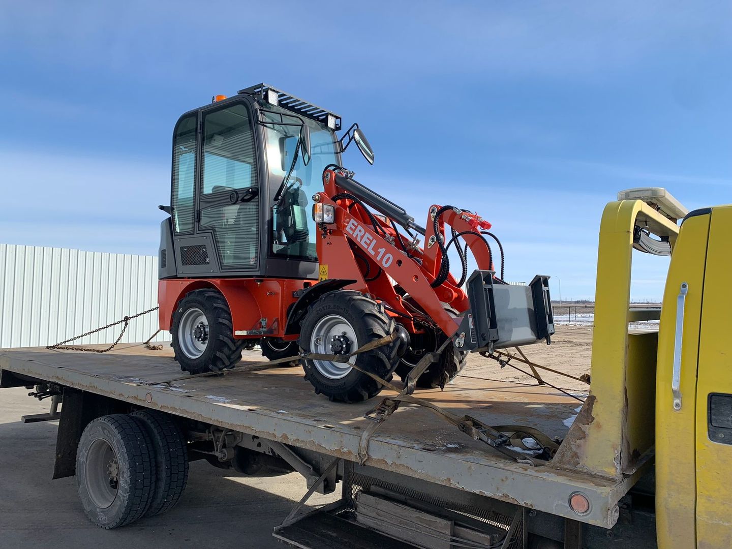 Towing a forklift on a flatbed tow truck in Winnipeg
