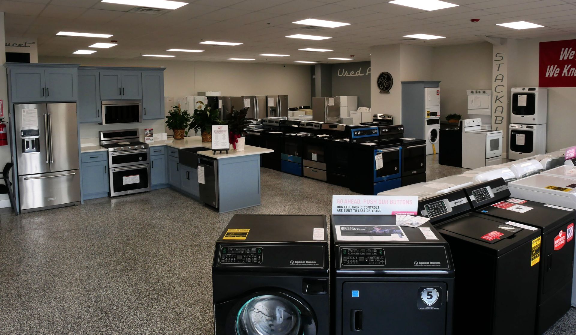 A store filled with lots of appliances including a washer and dryer.