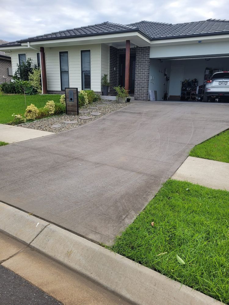 A Car is Parked in a Driveway in Front of a House — Mid North Coast Spray Pave in Port Macquarie, NSW