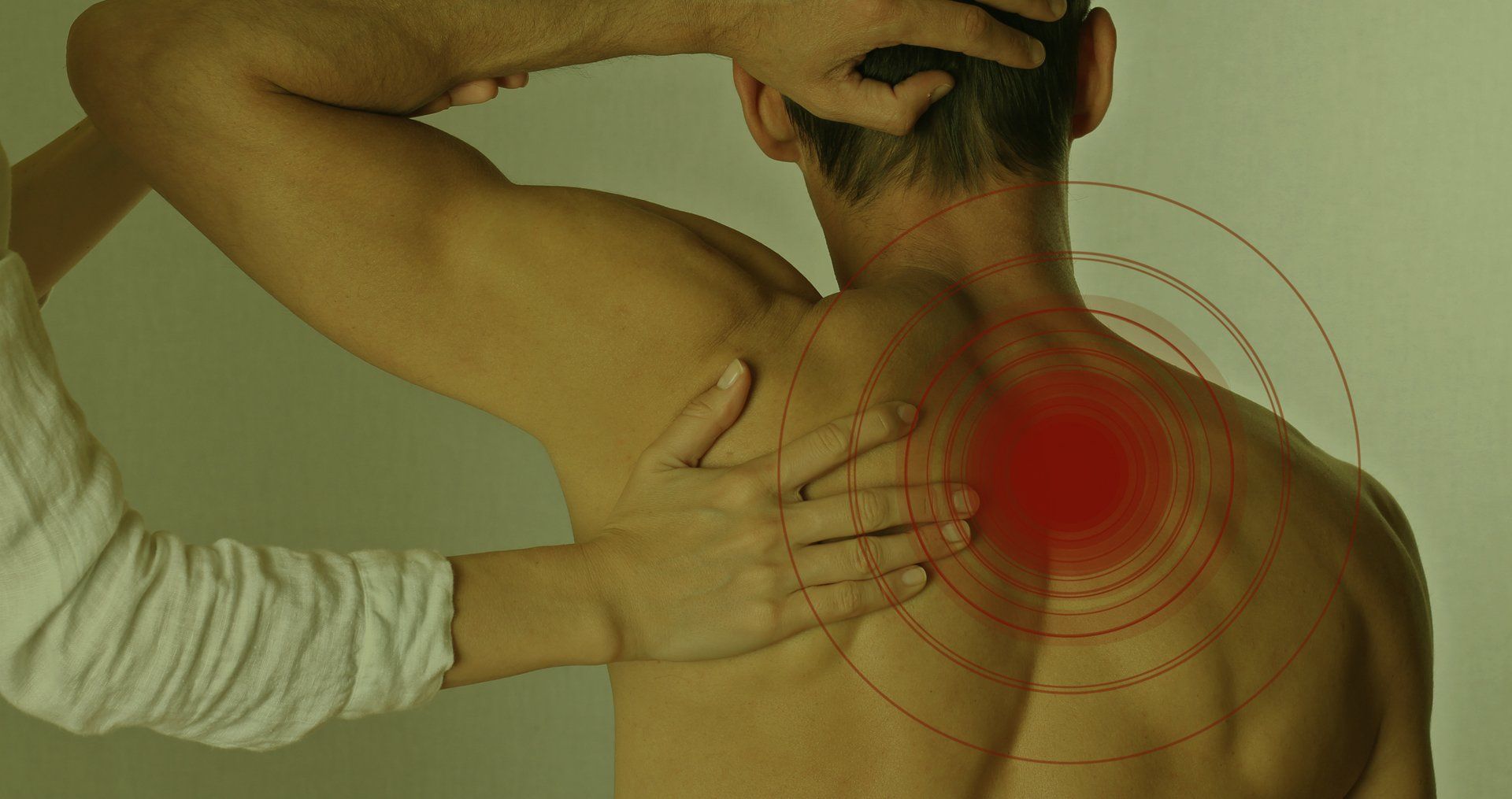 Chiropractor performing a shoulder adjustment to relieve neck and spinal pain during a chiropractic 