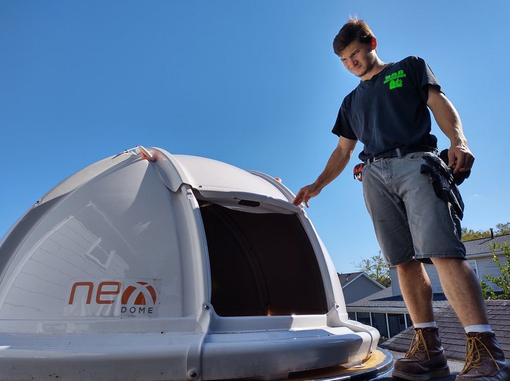 Man opening a rooftop Neo Dome with a blue sky background.
