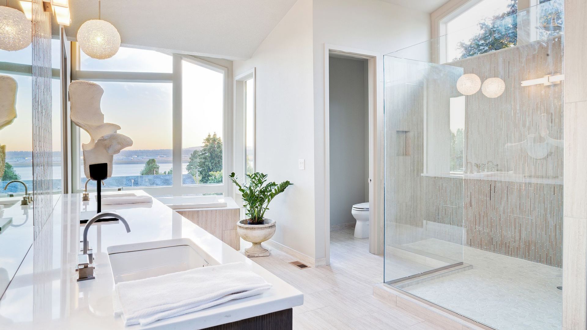 A bathroom with a sink and a walk in shower
