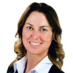Woman with brown hair, smiling, wearing a white collared shirt and black jacket.