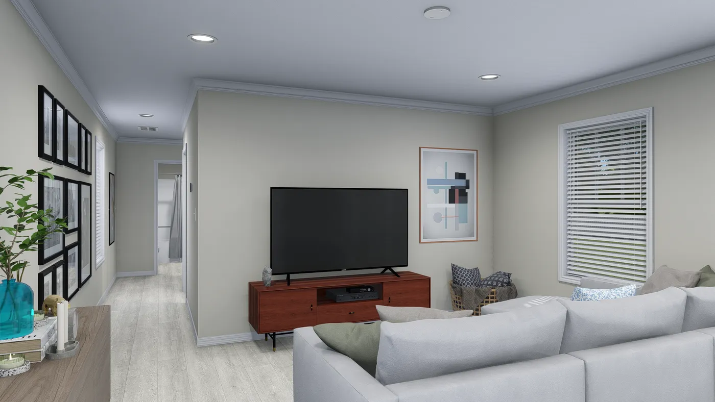 Living room with a sectional sofa, TV, and hallway.