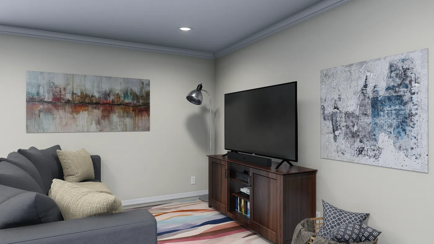 Living room with a dark sectional, TV, and abstract art pieces.