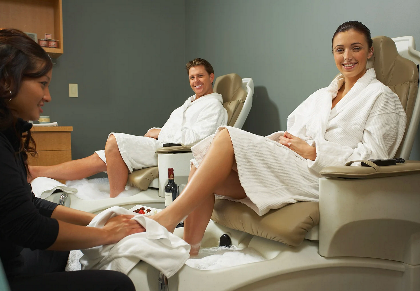Two women are getting their feet massaged in a spa.