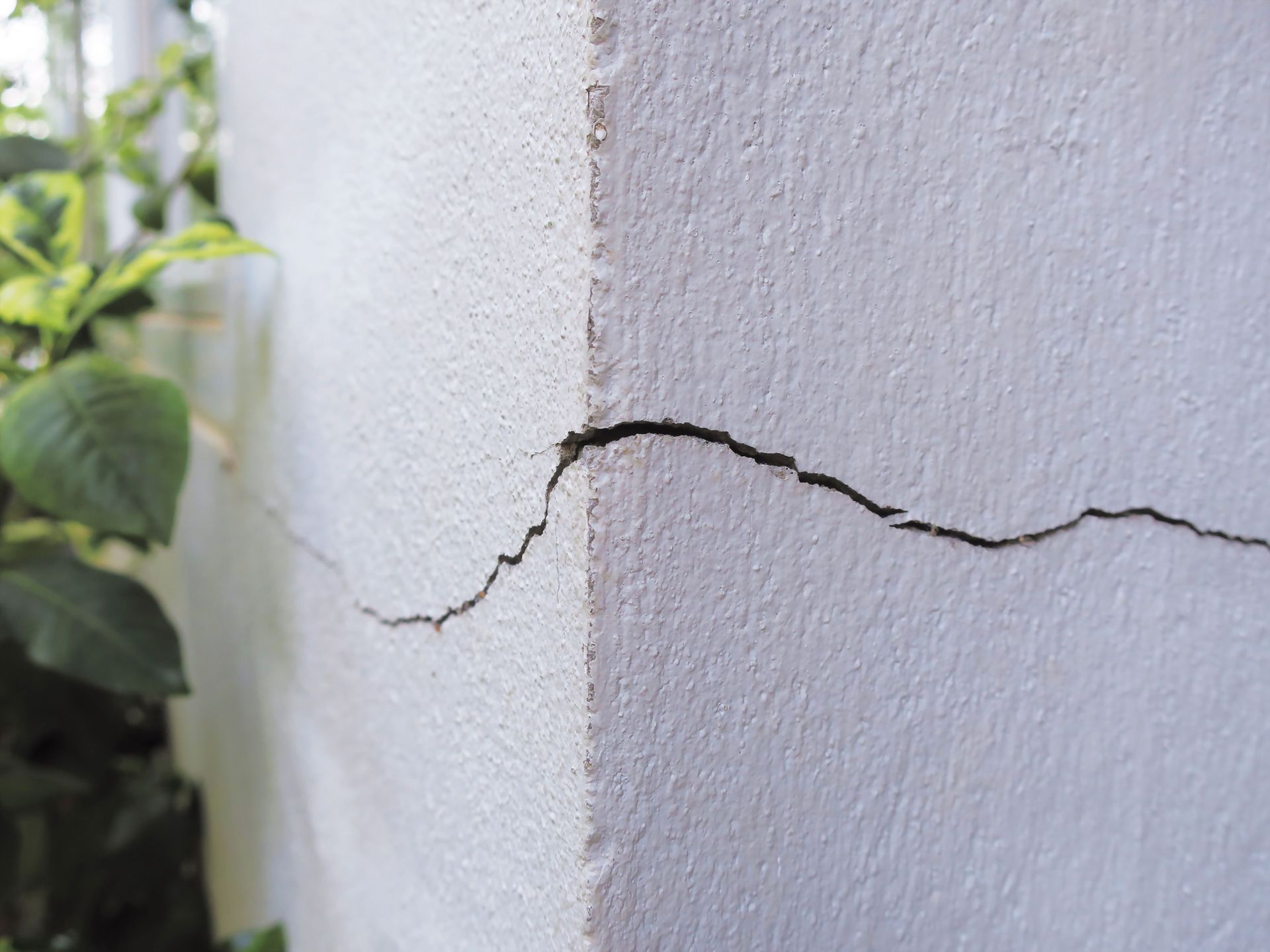 large crack in corner of concrete foundation of residential home