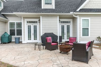 stamped concrete patio in backyard with furniture
