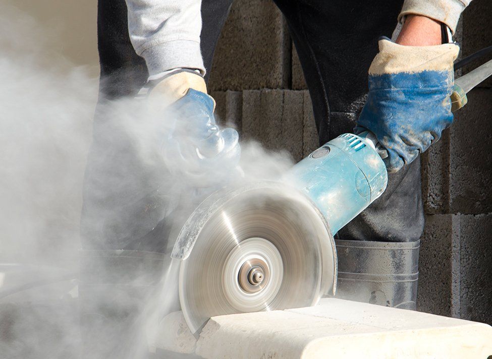 Man Holding Concrete Saw — Crossett, AR — Master Technicians & Mechanicals LLC