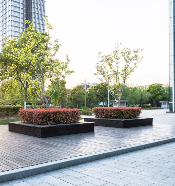 A couple of planters with flowers in them on a sidewalk