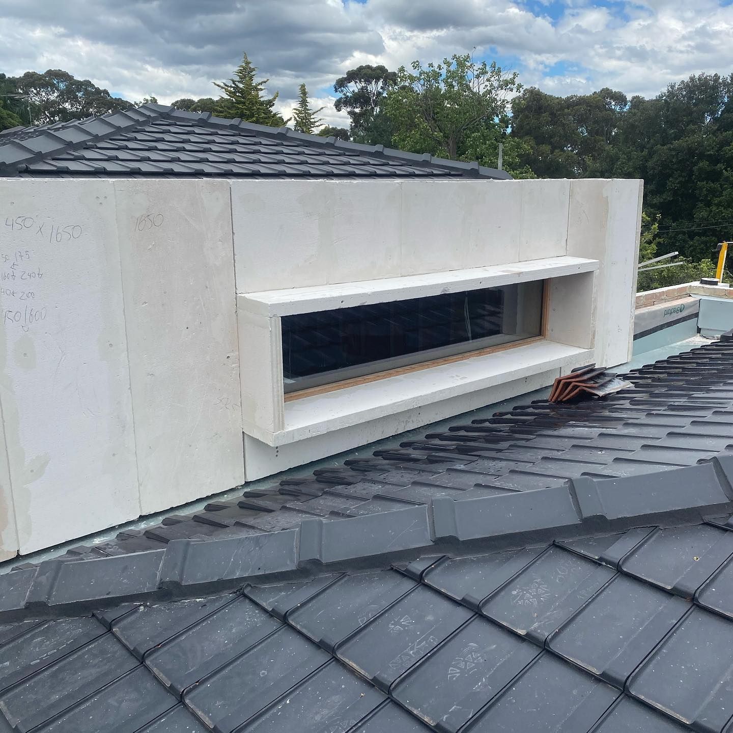 There is a window on the roof of a house.