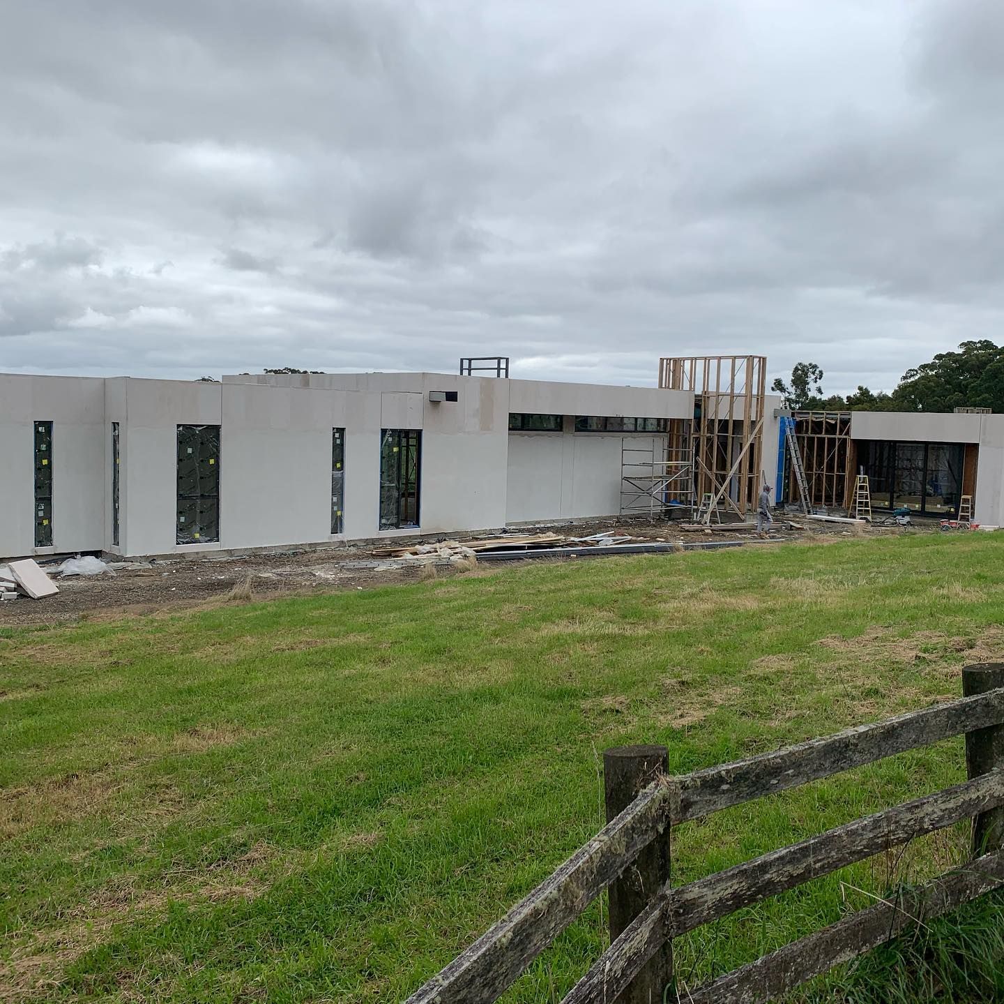 A balcony with sliding glass doors and a red bucket