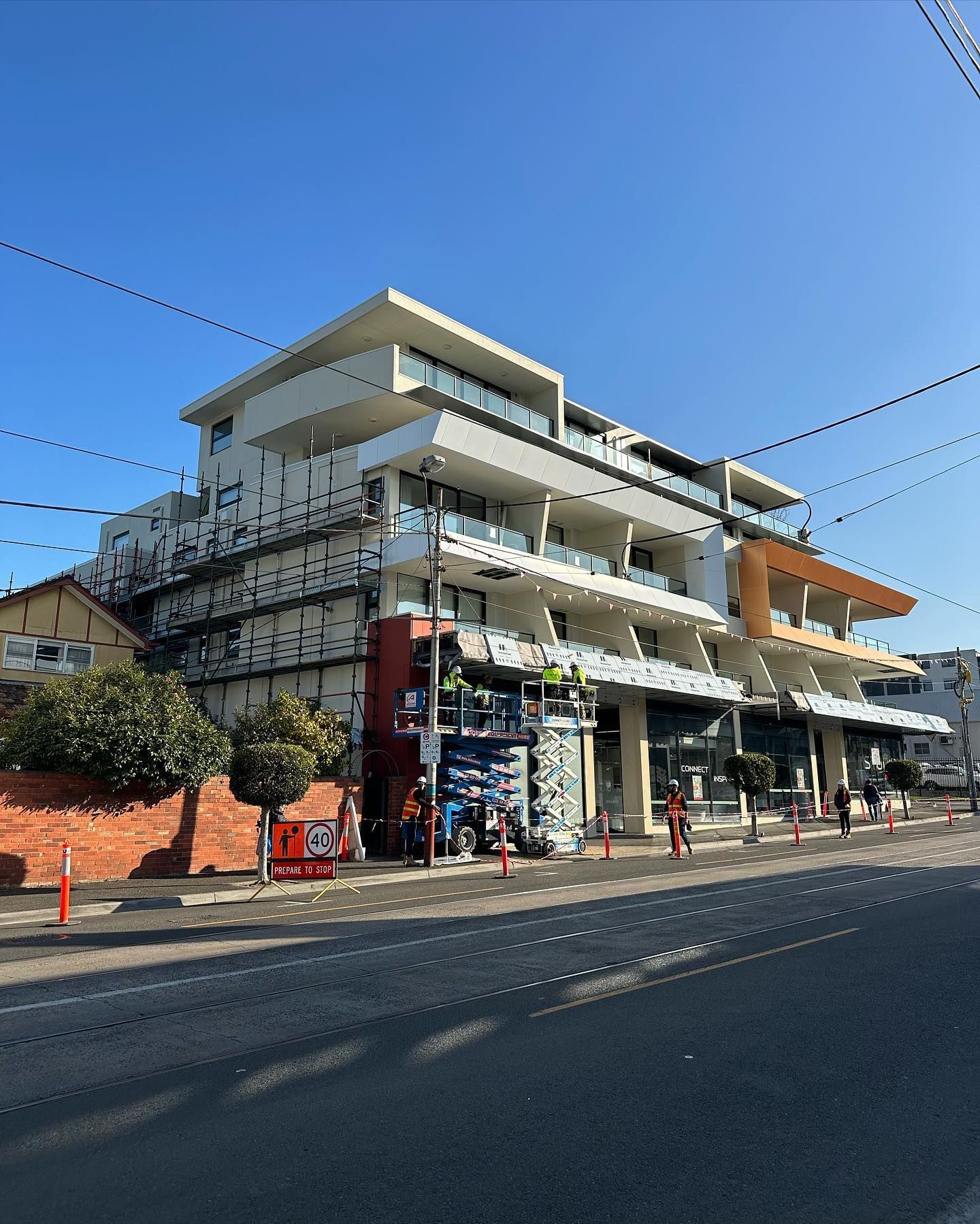 A large building is being built next to a street.