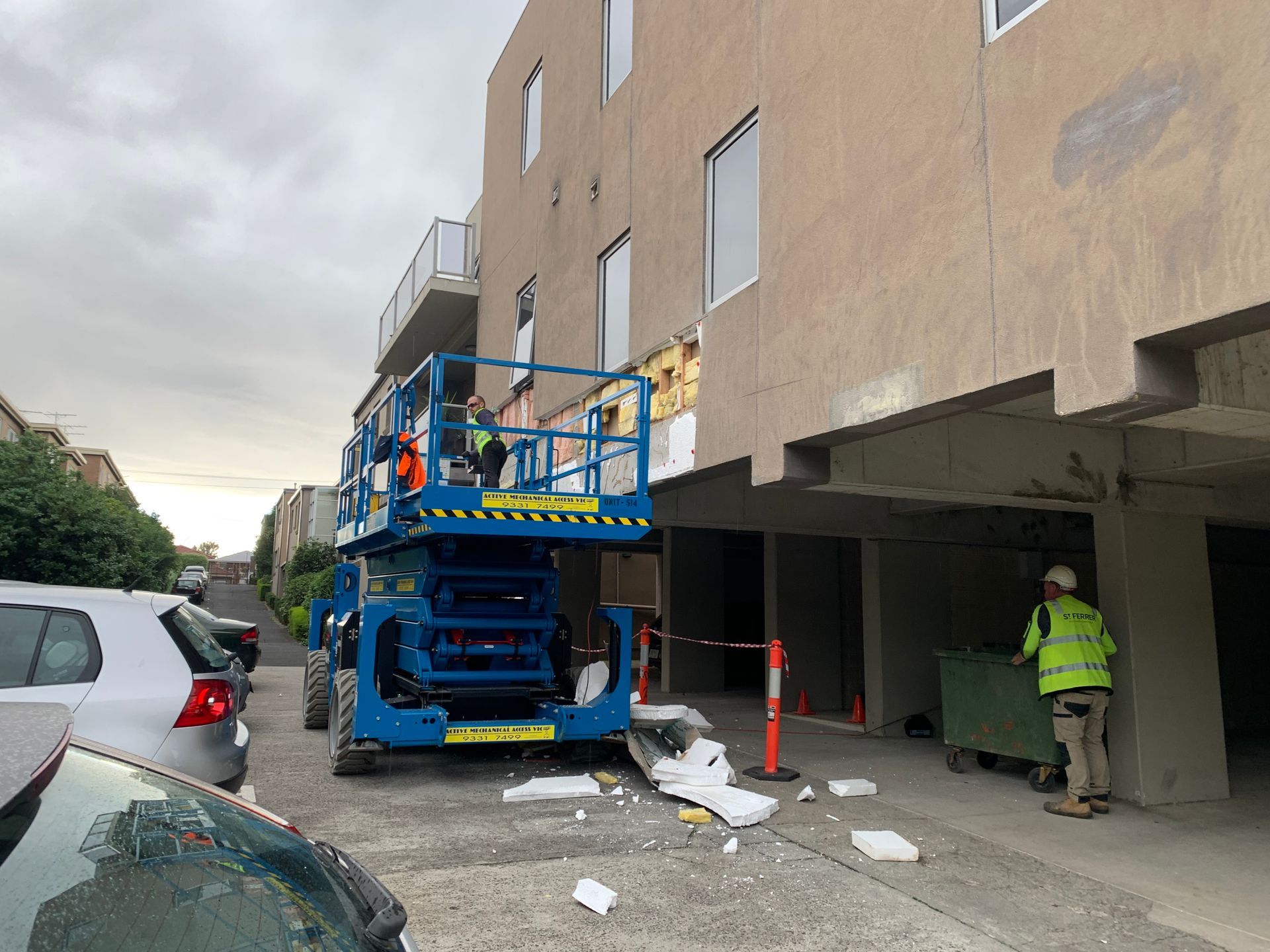 A construction vehicle is parked in front of a building.