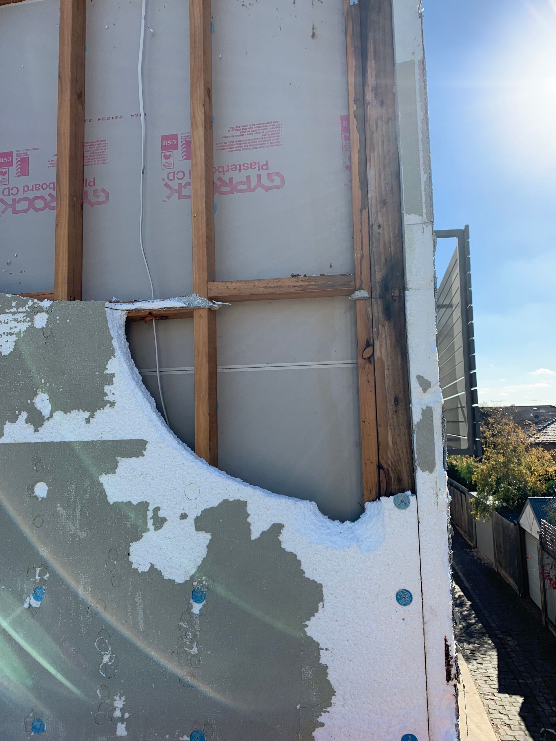 A piece of styrofoam is missing from the side of a building