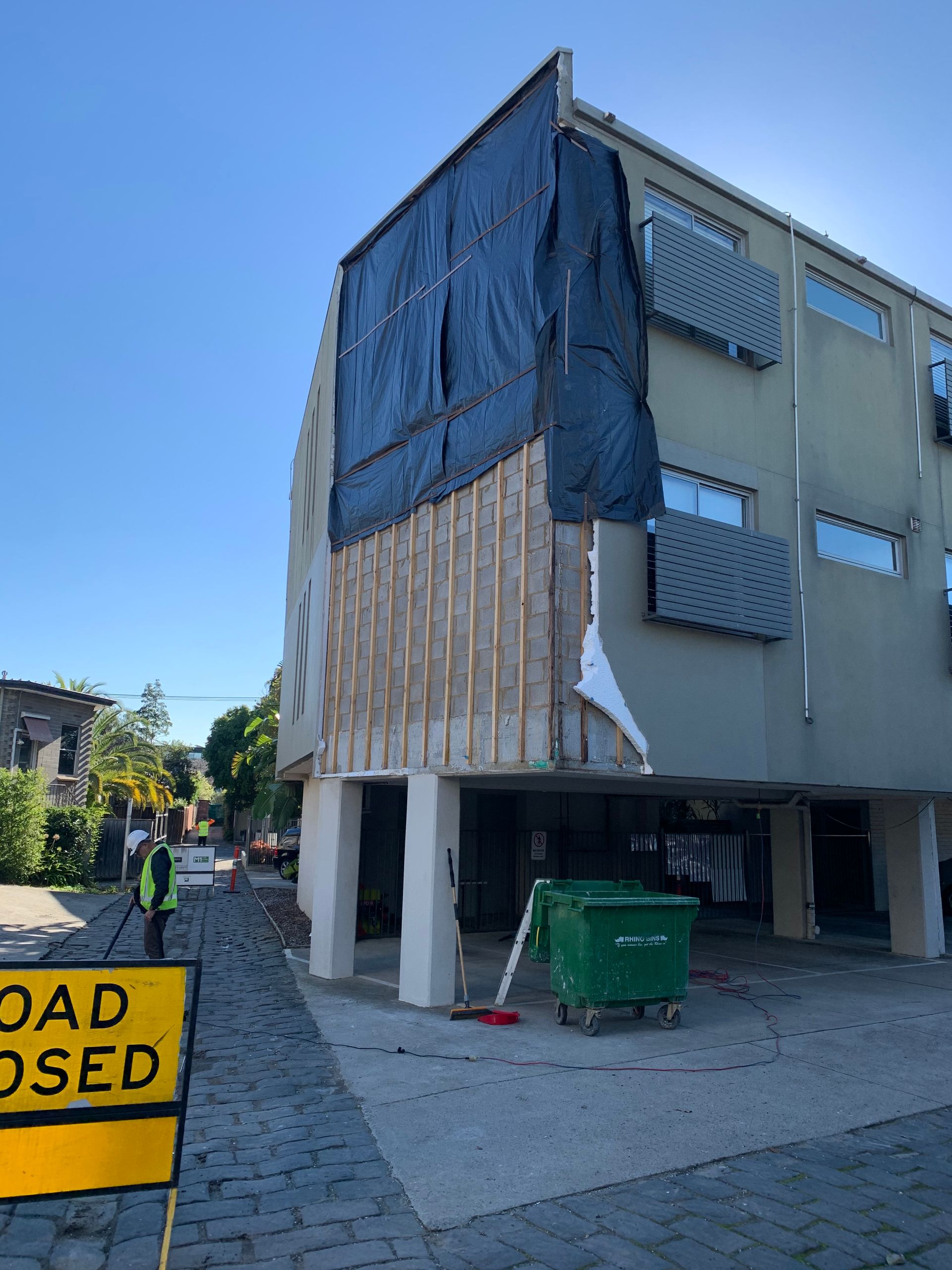A yellow sign that says road closed in front of a building