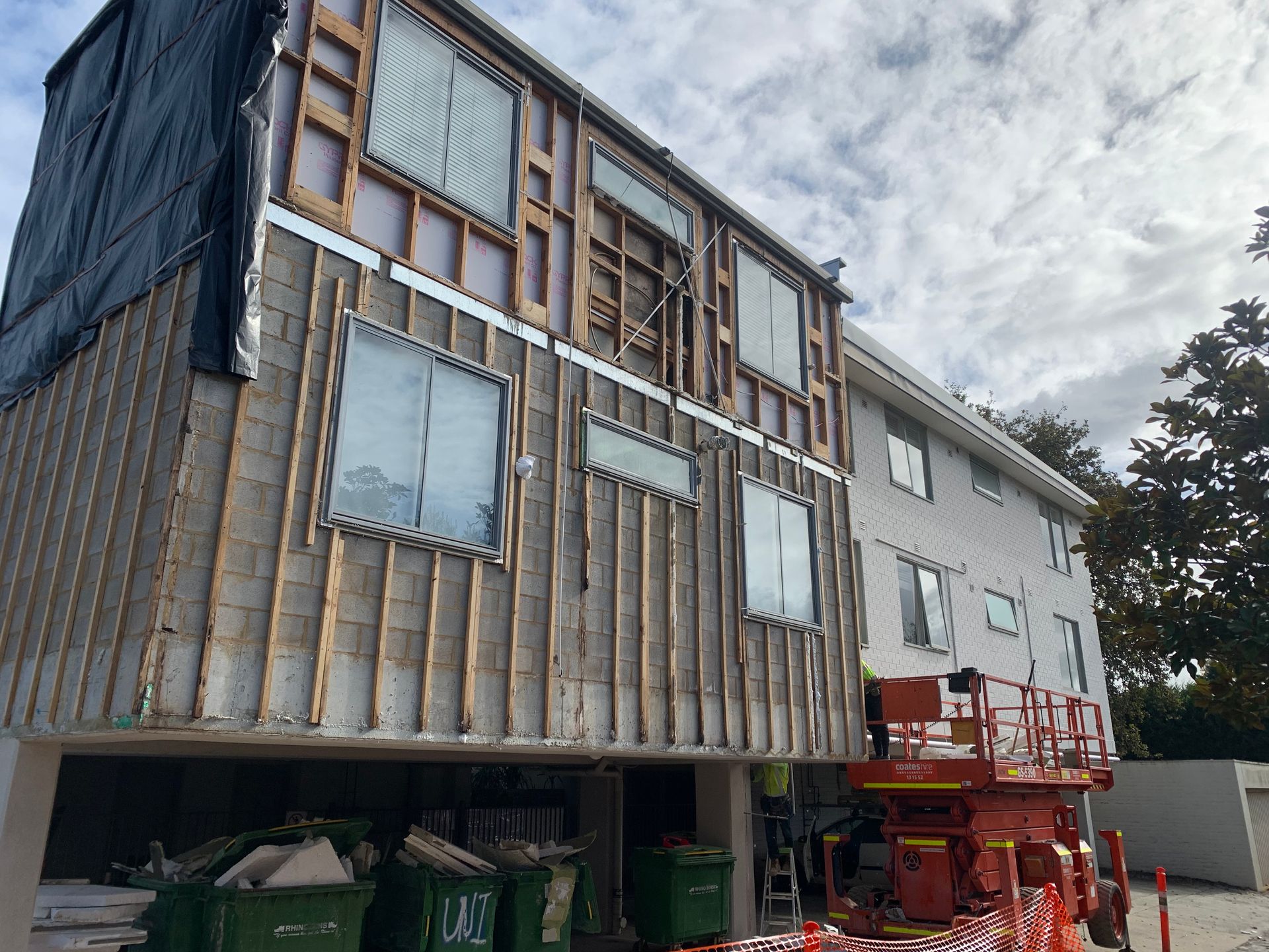A large building with a lot of windows is being built.