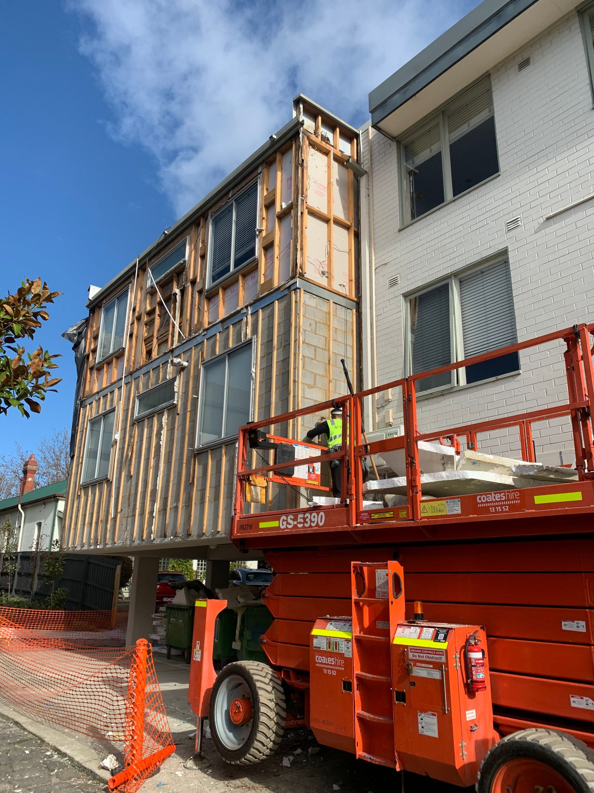 A construction vehicle is parked in front of a building