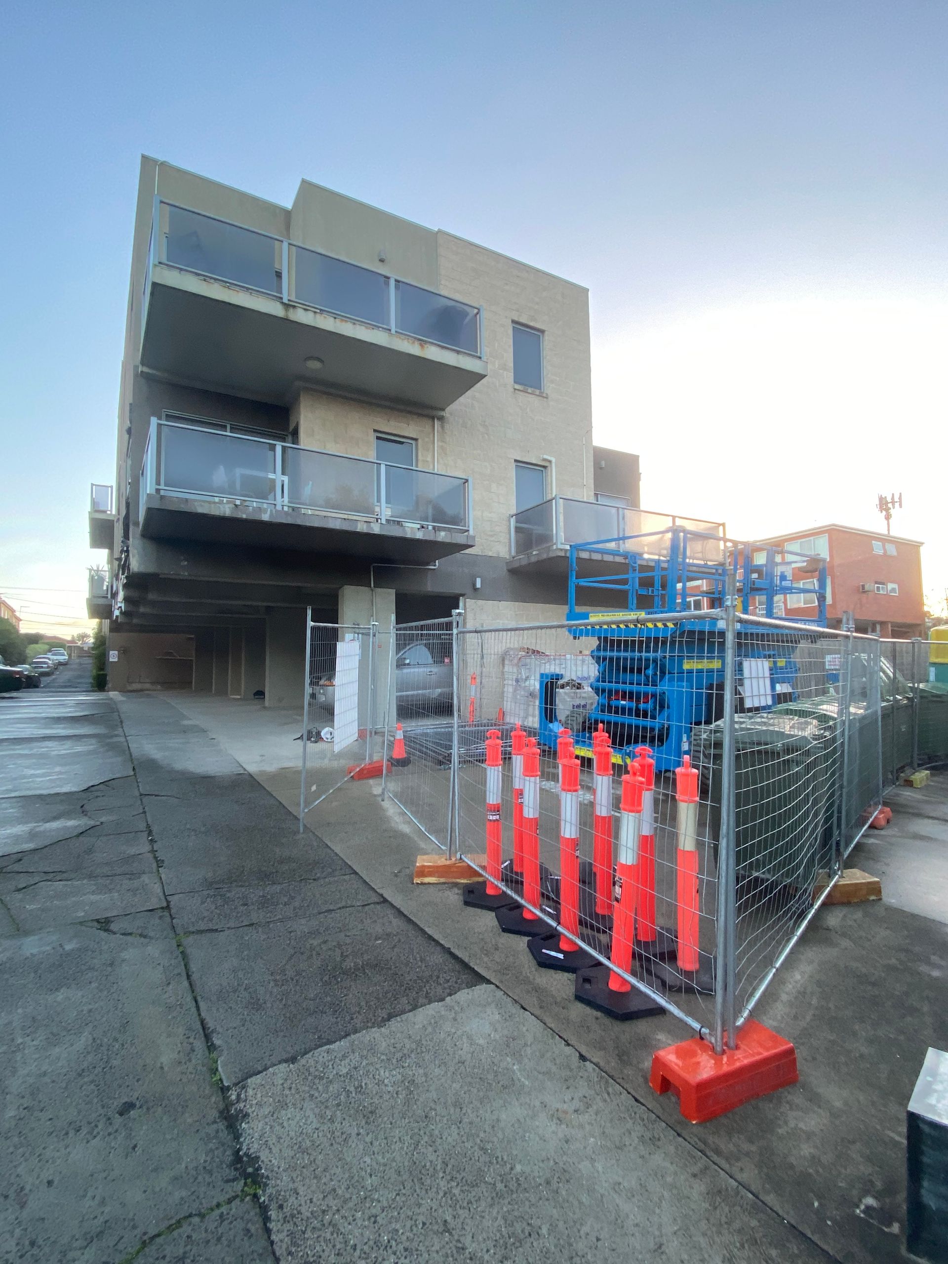 A building under construction with a fence around it.