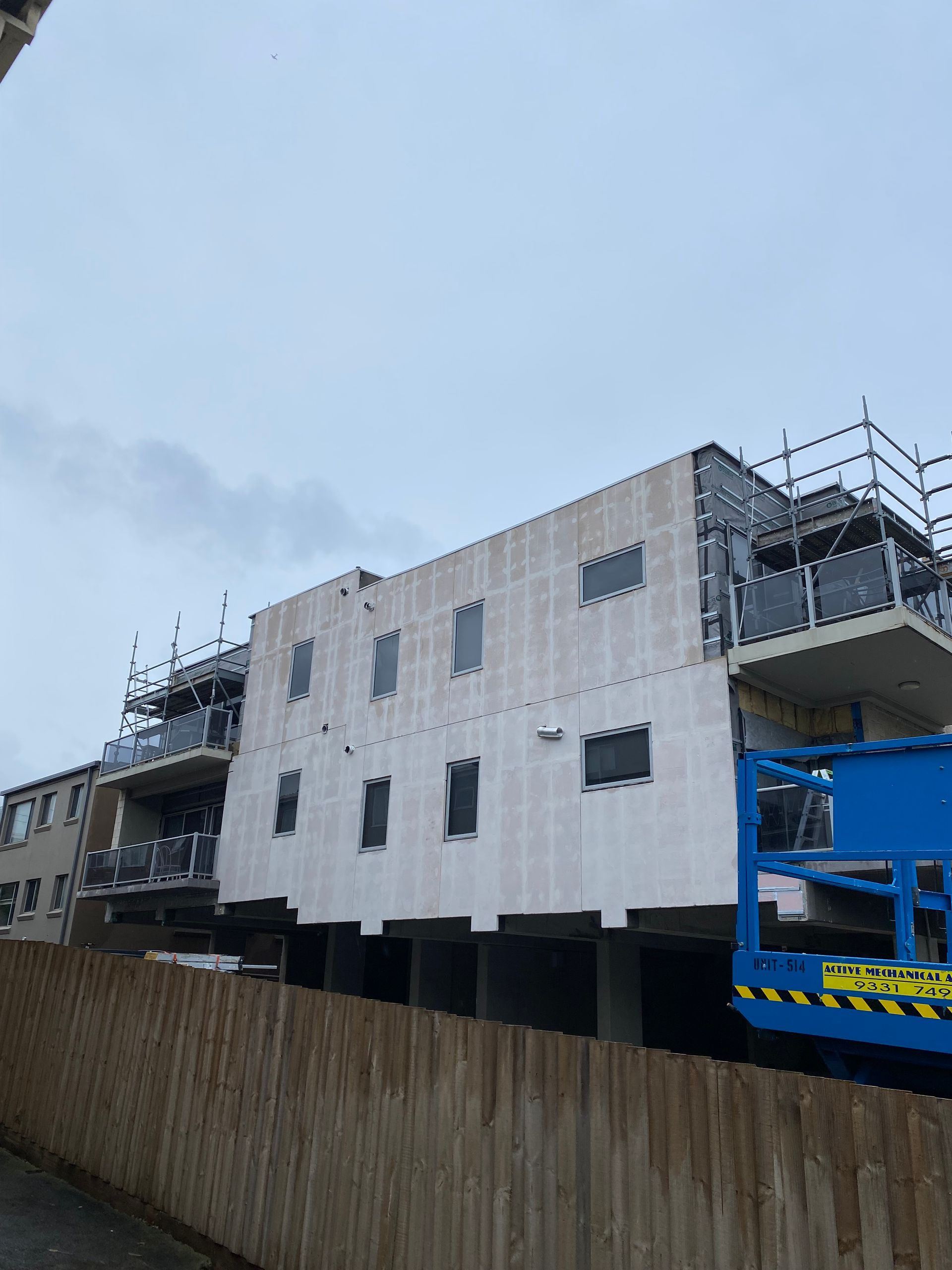 A large building under construction with scaffolding on top of it.