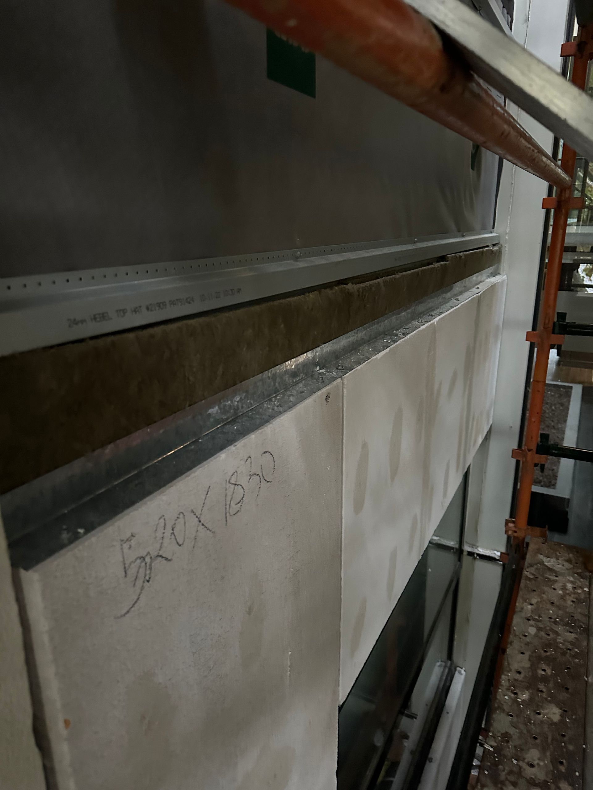 A close up of a wall with a scaffolding around it