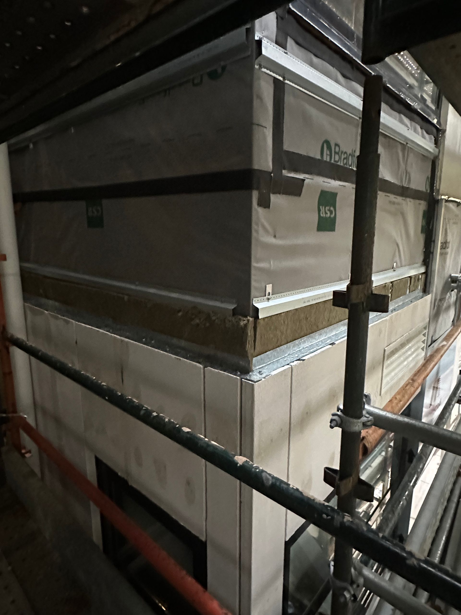 A corner of a building with scaffolding around it