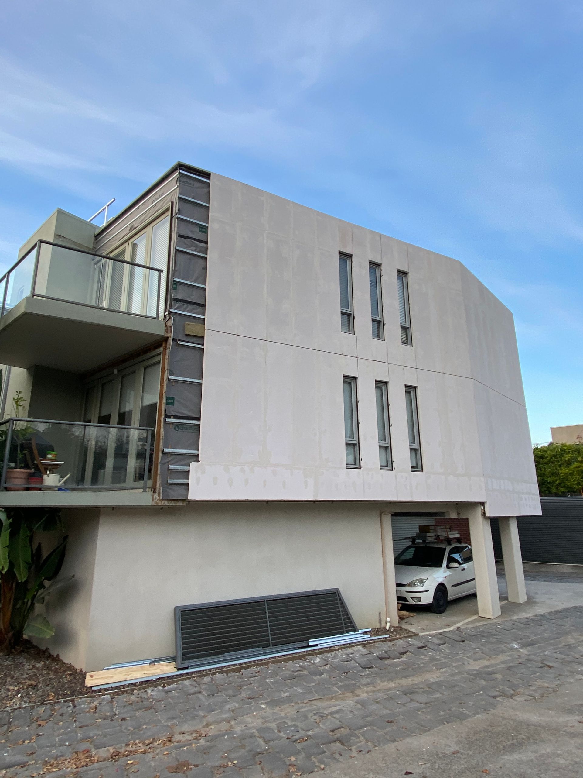 A large building with a car parked in front of it