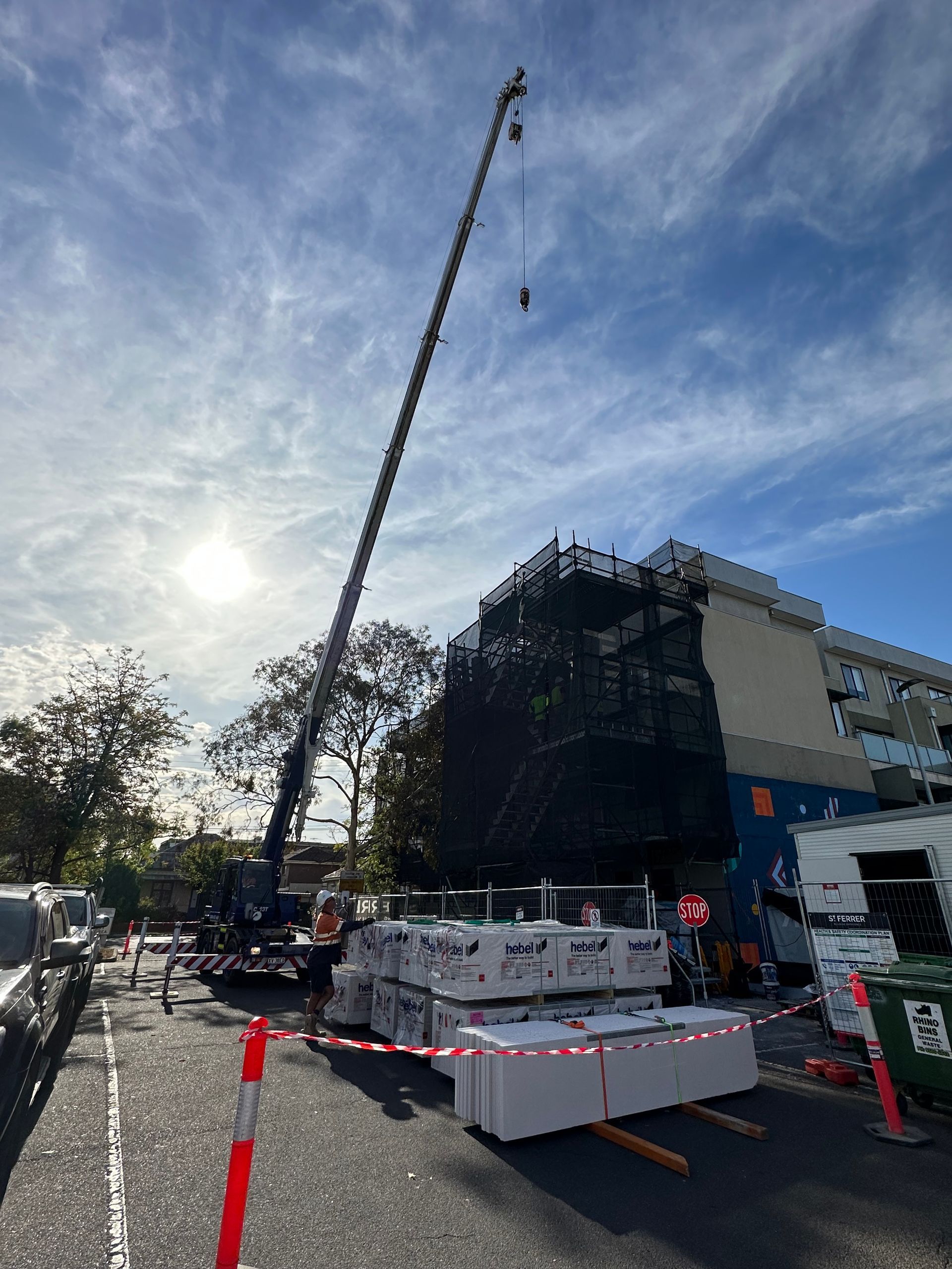 A large crane is being used to lift a building