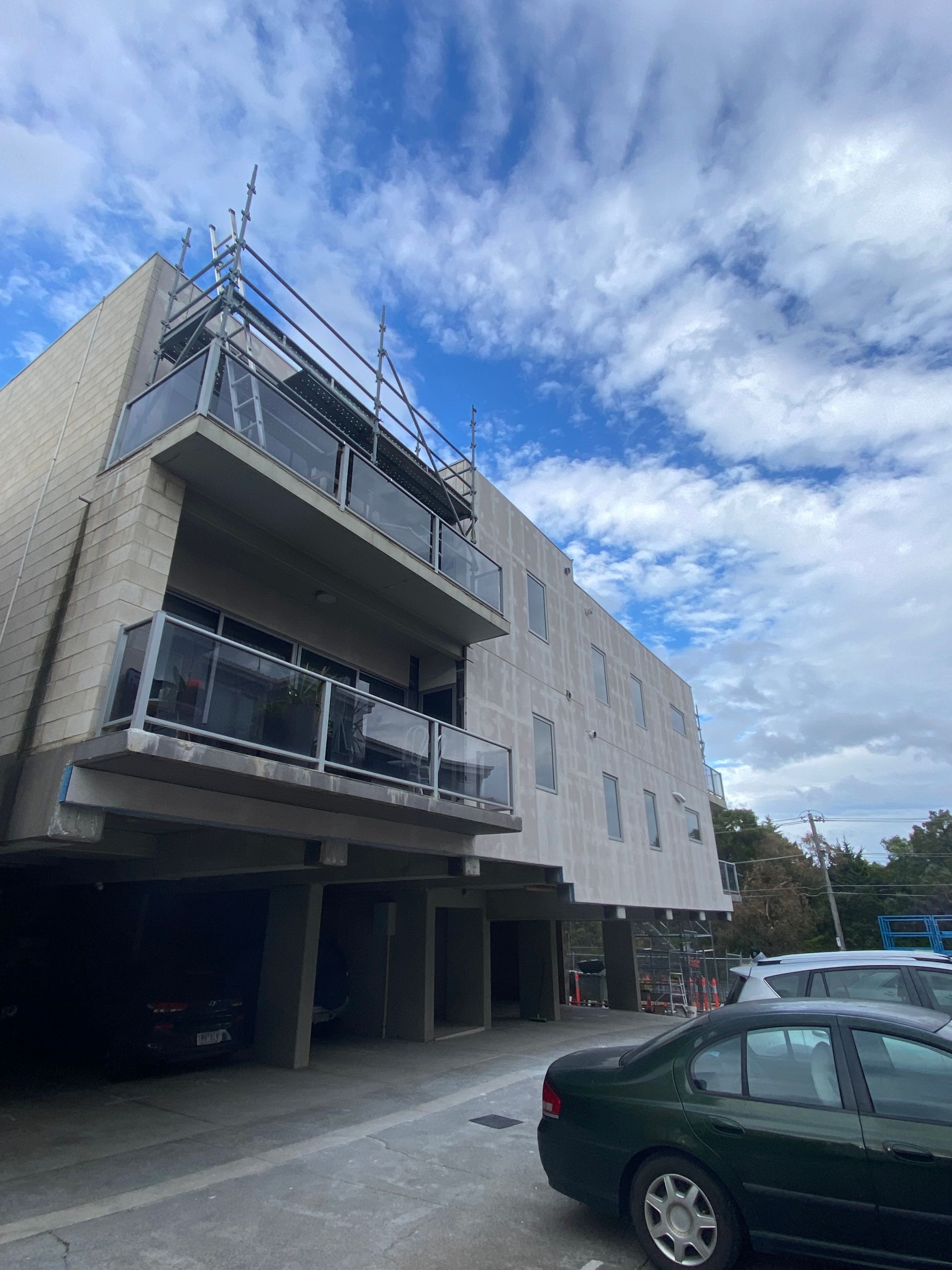 A building with a lot of cars parked in front of it