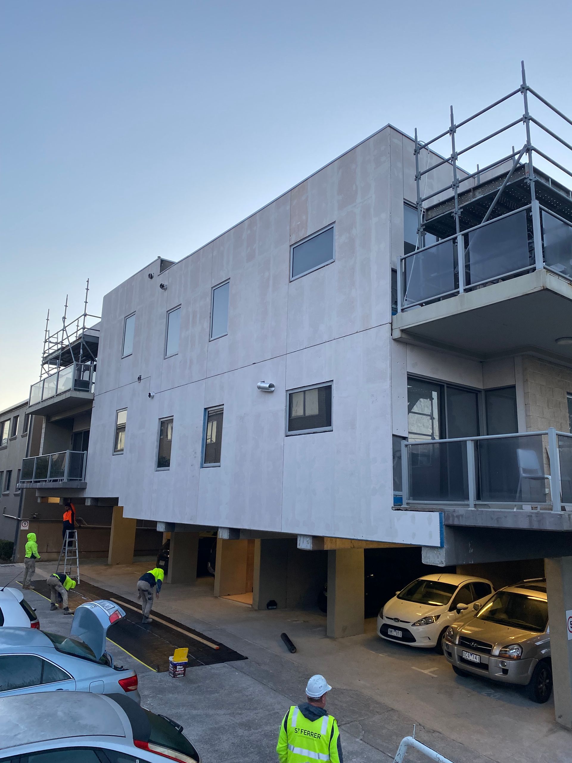 A large building with cars parked in front of it