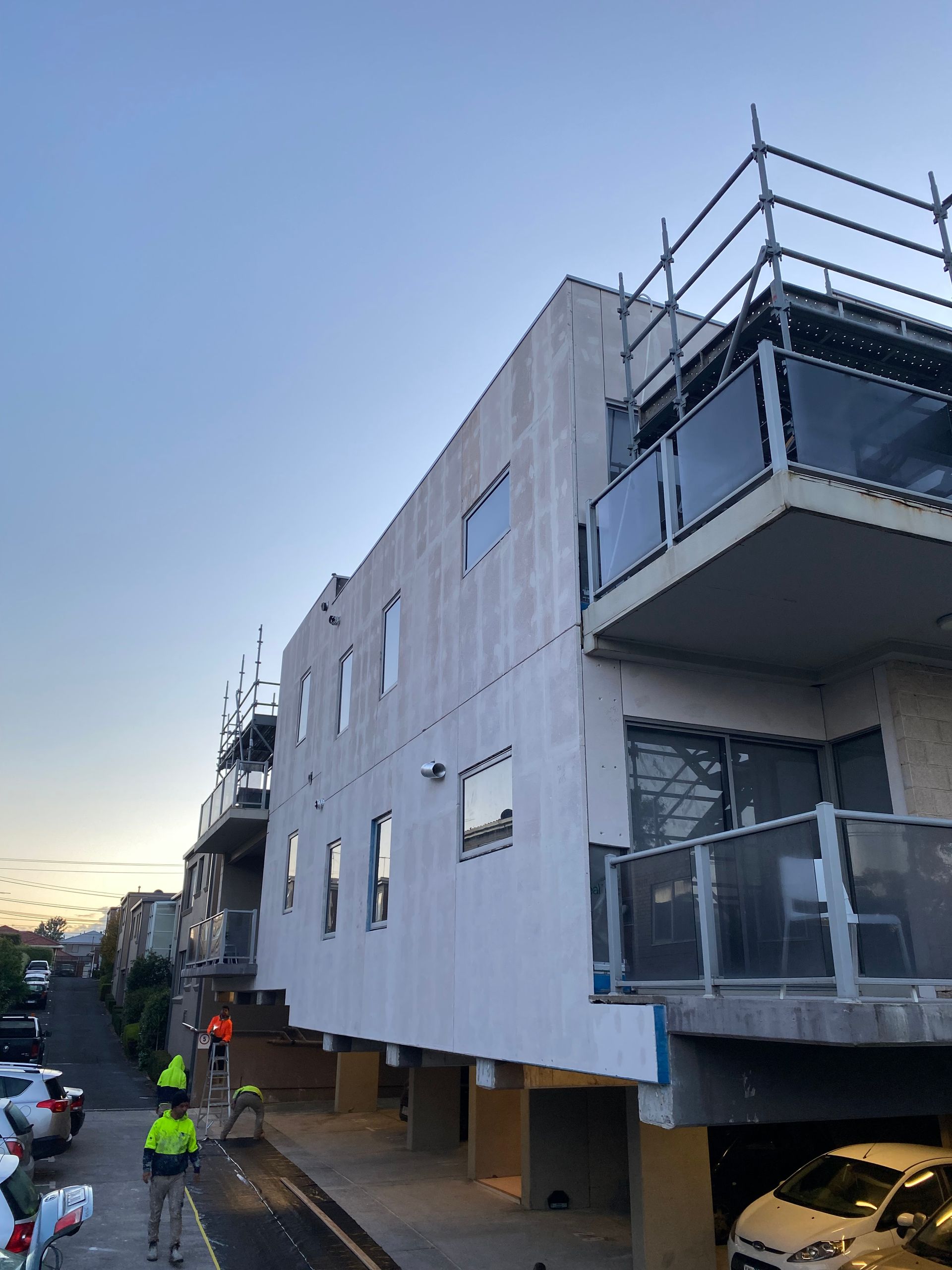 A building with a balcony and scaffolding on it