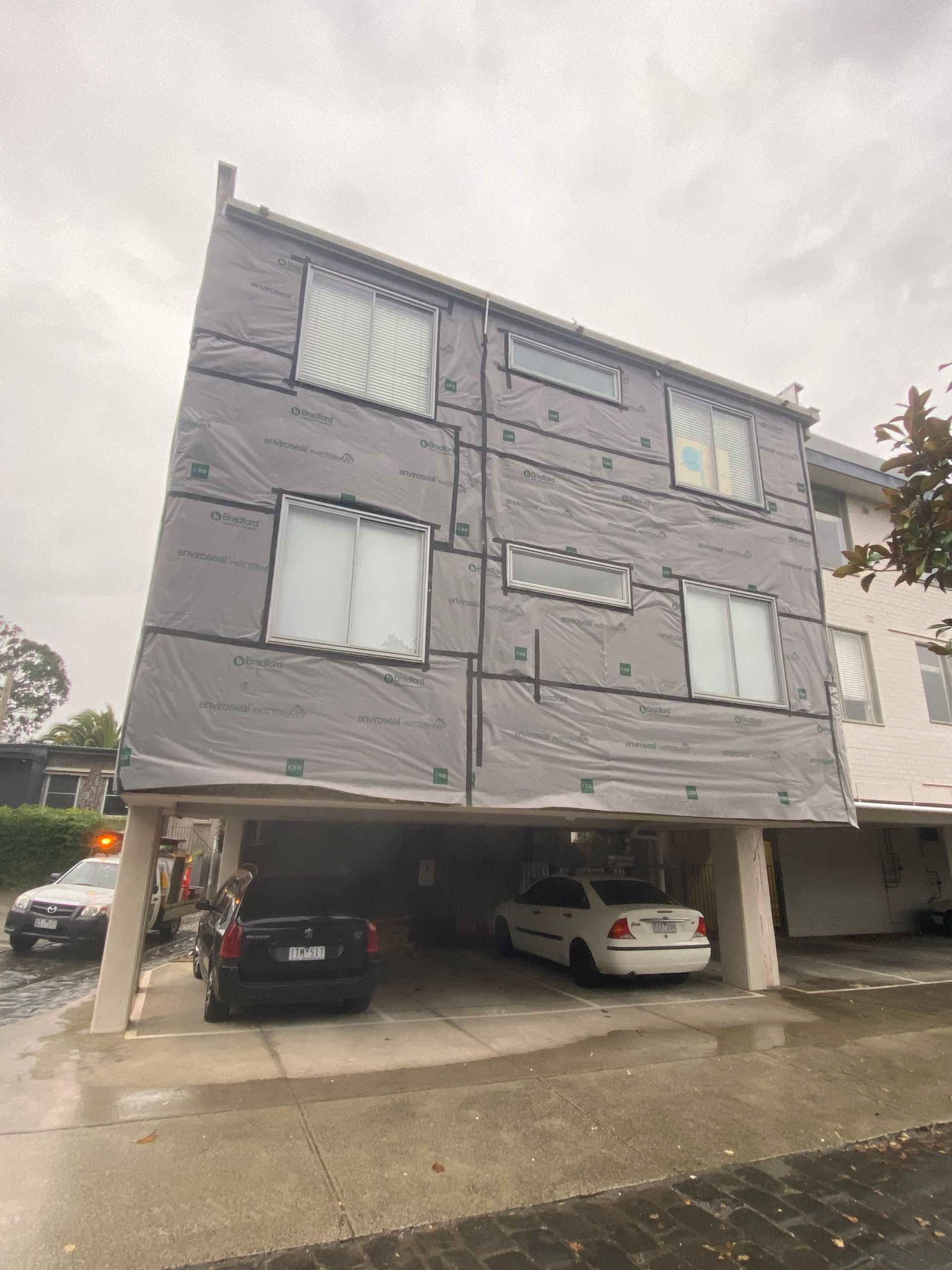 A building with a lot of windows and cars parked in front of it