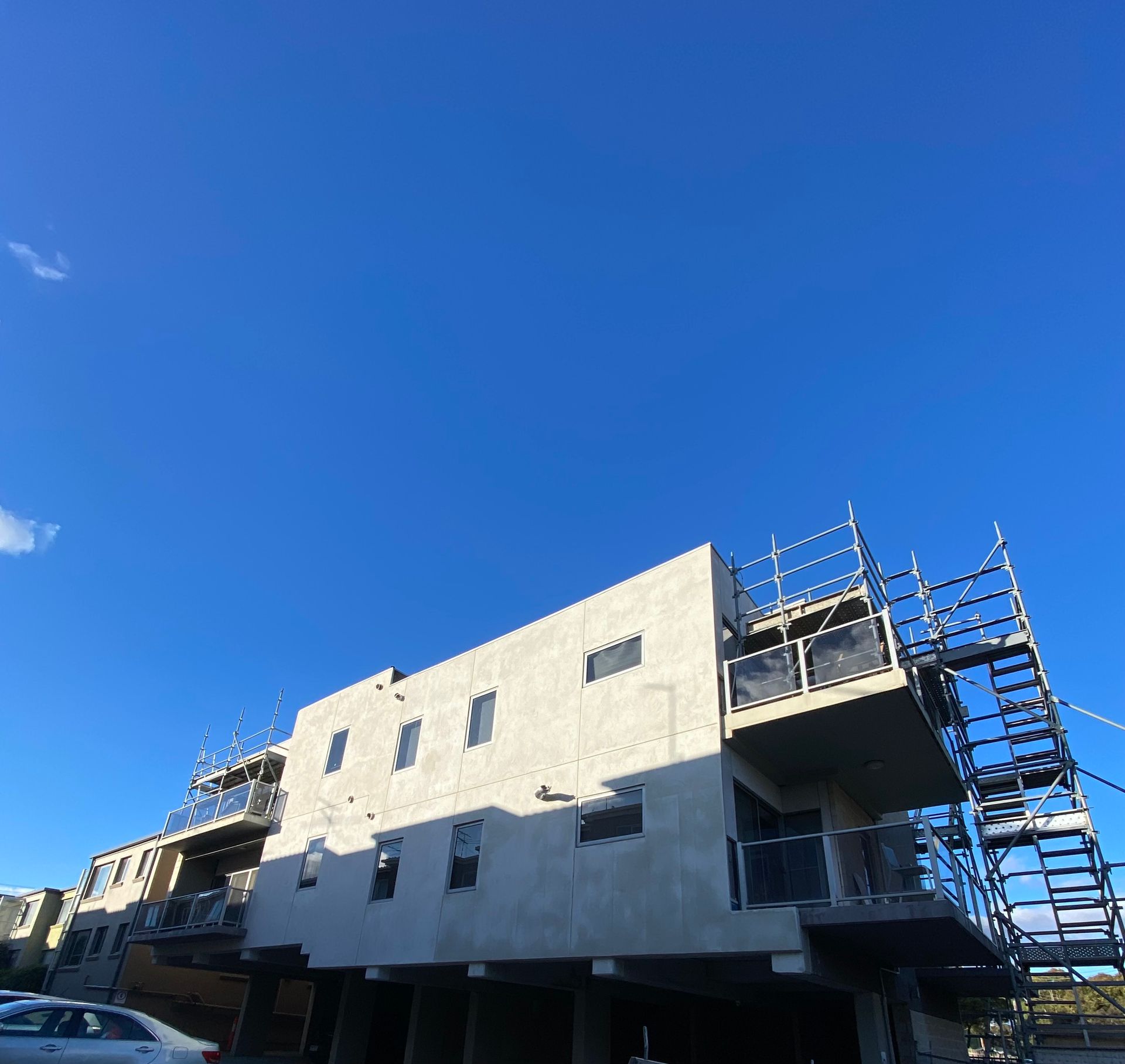 A building under construction with stairs on the side of it