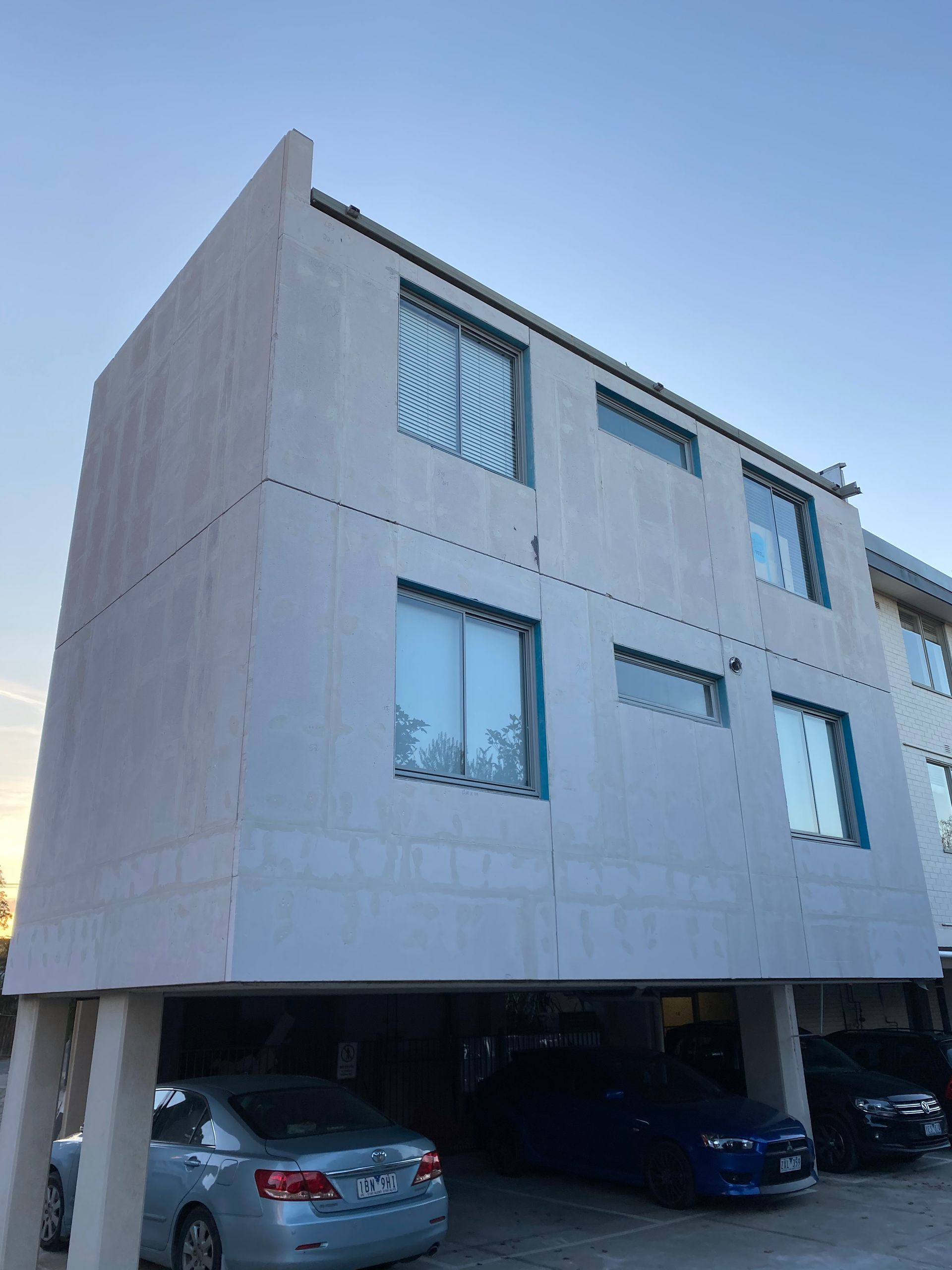 A building with cars parked underneath it