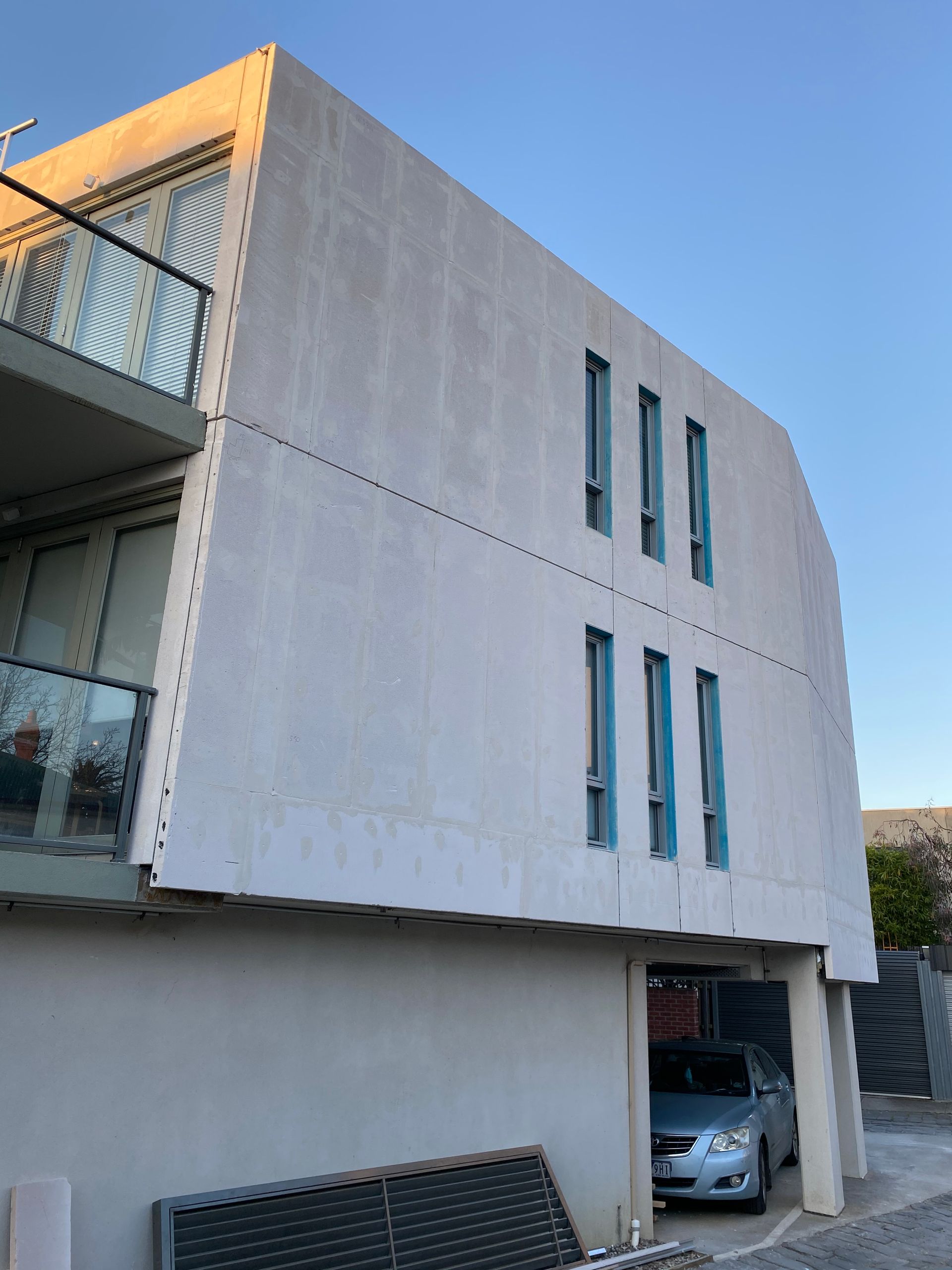 A building with a car parked in front of it